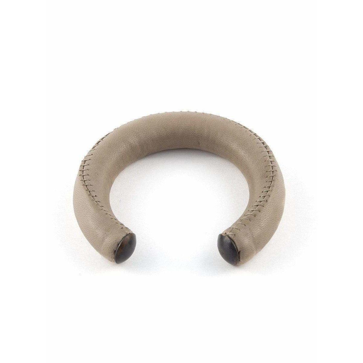 Leather Molded Bangle in light stone with stitch detailing and metal tips from Damir Doma. 