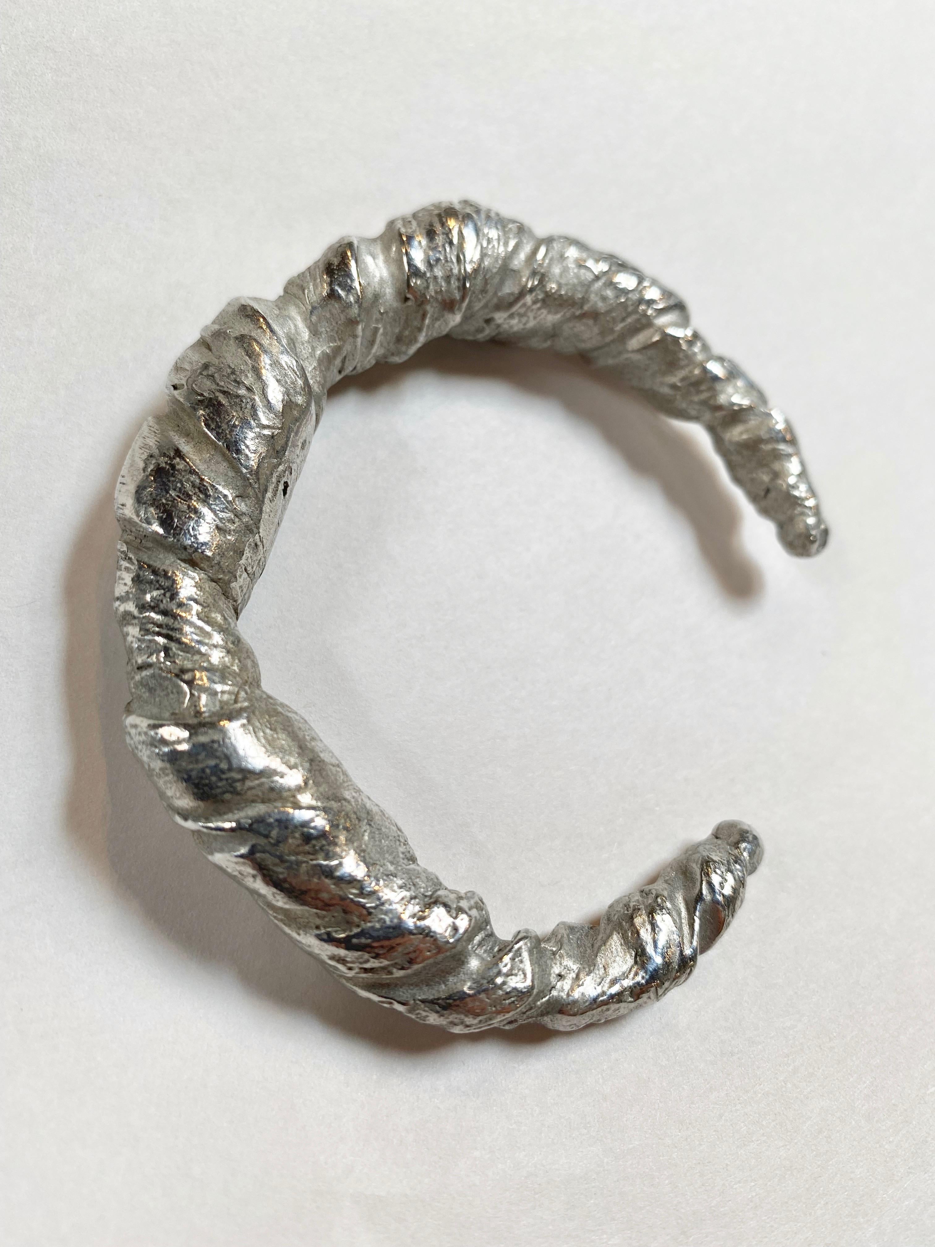 Wrapped silver bangle bracelet with a crinkled fabric effect from DAMIR DOMA. 