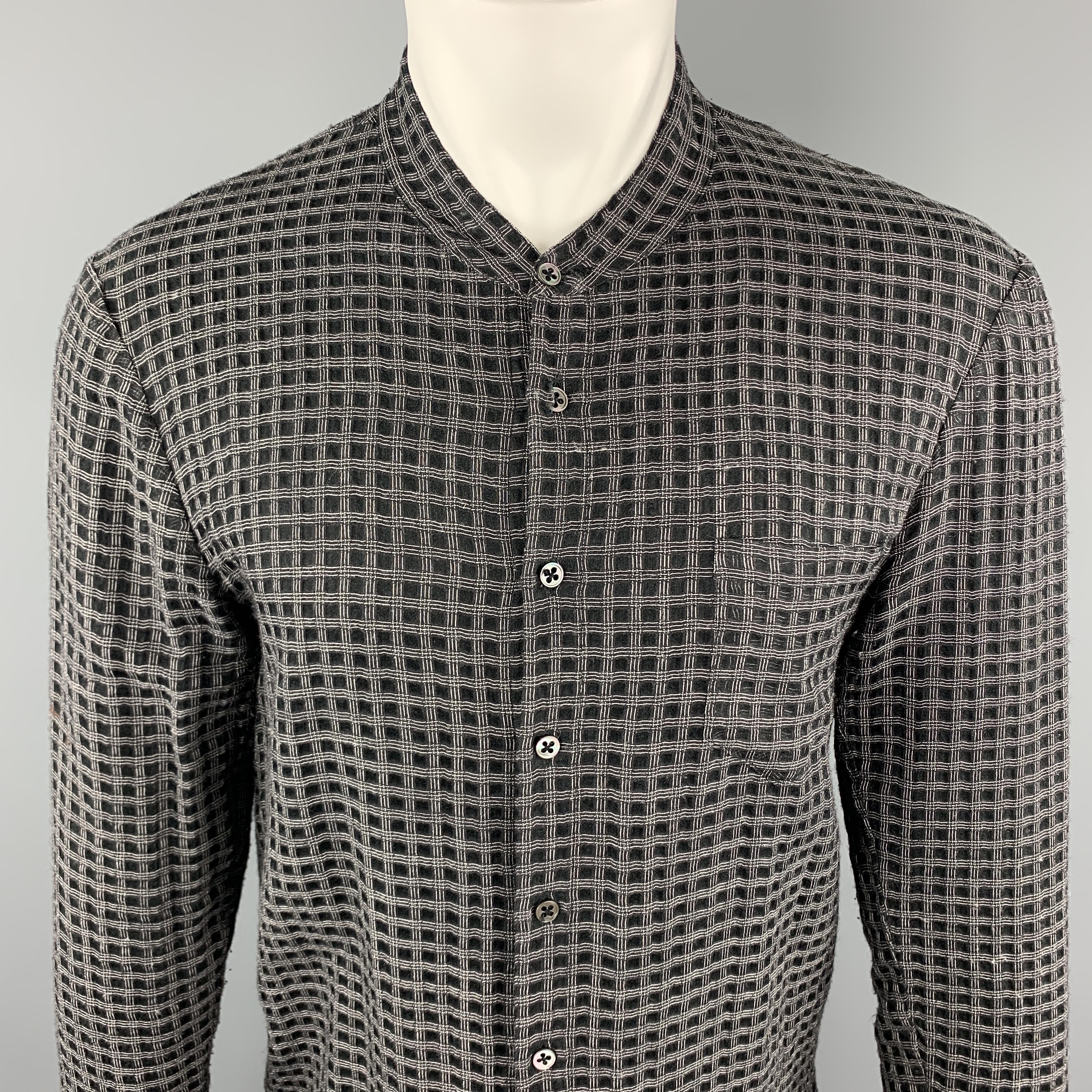 DAMIR DOMA Long Sleeve Shirt comes in black and grey window pane wool / silk material, with a nehru collar, a patch pocket, a buttoned front, buttoned cuffs, vent at sides, in a tunic style. Missing one button at right cuff. Made in Italy. 

Good