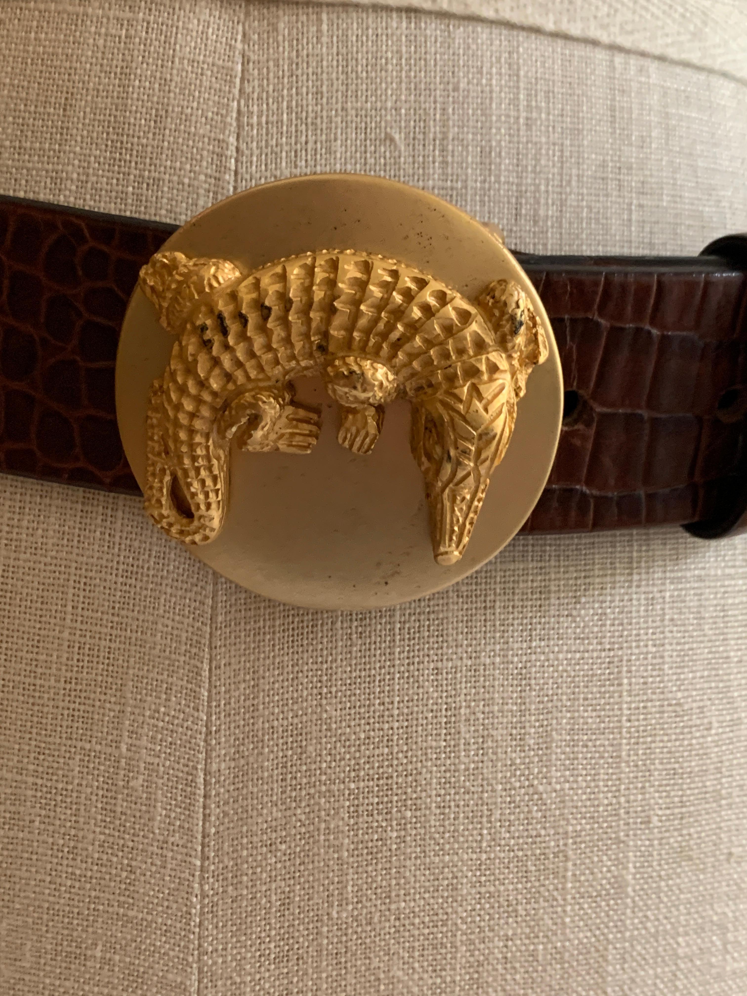 Dan Azan vintage crocodile embossed leather belt with gold circular buckle featuring a stylized crocodile. Peg and hole closure. 

1 3/8