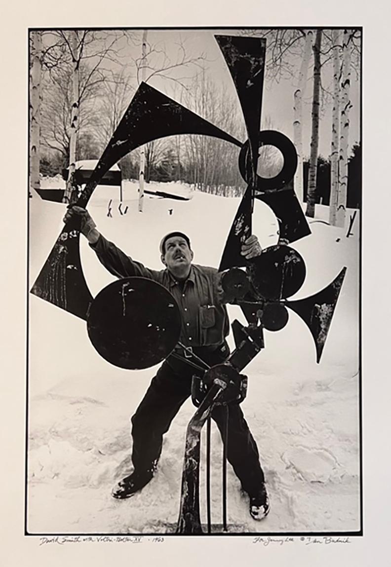 DAN BUDNIK (American, b. 1933-2020
David Smith with Voltr1-Bolton XV, Terminal Iron Works, Bolton Landing, N. Y. 1963
Vintage Print on Afga Paper, Silver gelatin, March 1963, printed 1992 by Igor Bakht
Paper: 24 x 20 inches 
Image: 16.38 x 13 inches