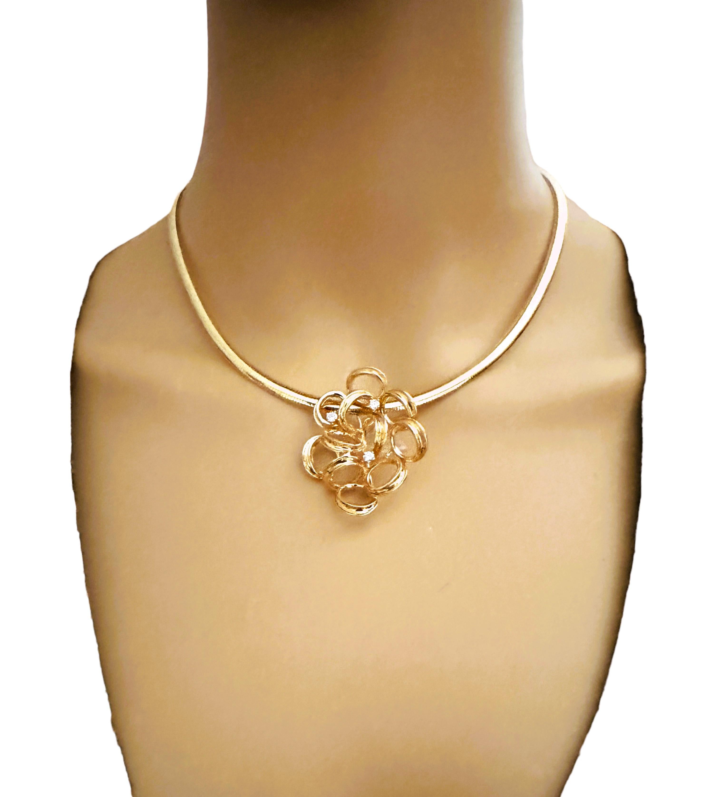 Dan Frere 14 karat gold and round diamond modern pendant. It is stamped 