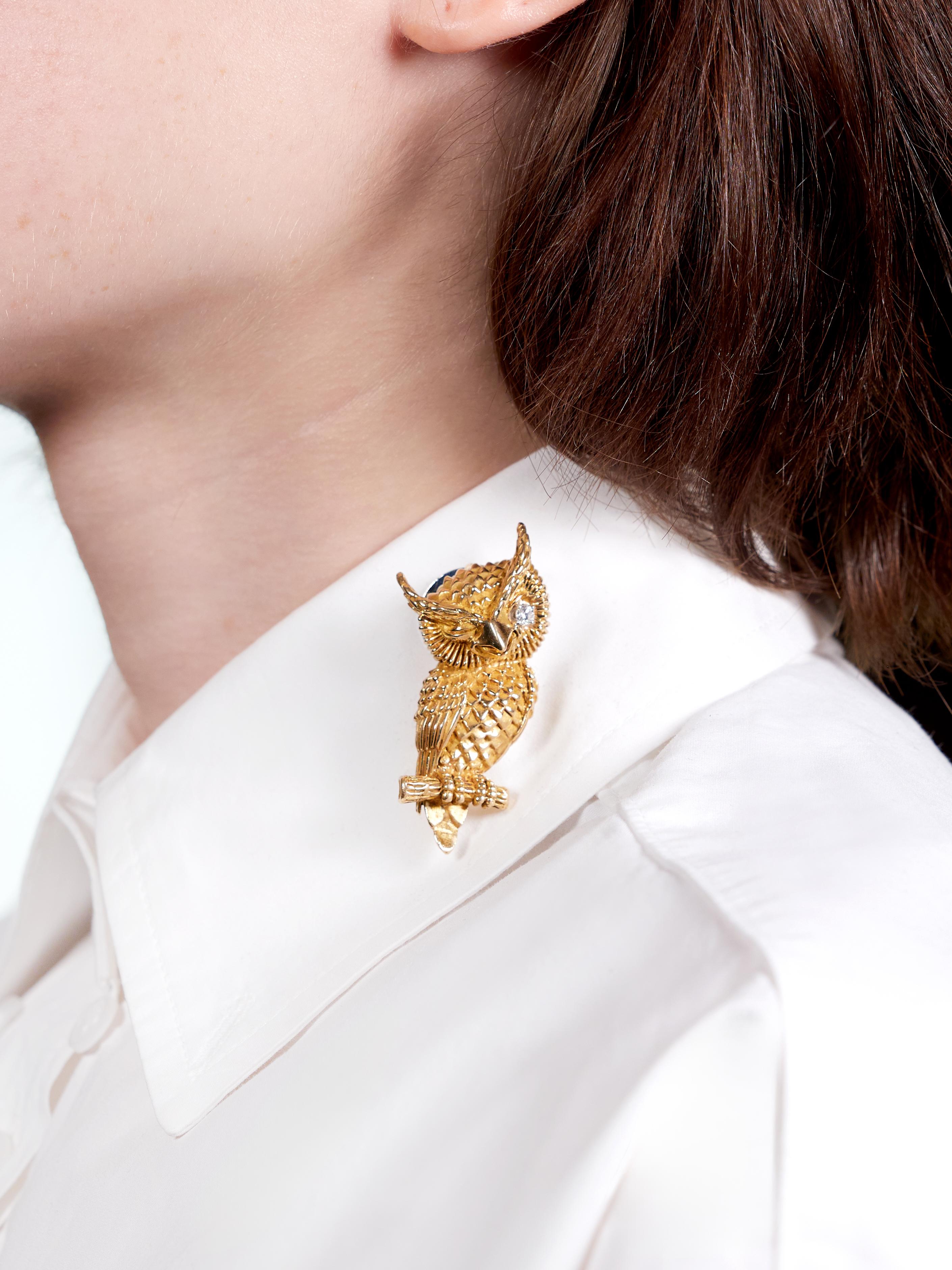 Designed as a stylized owl depicted perched on a branch and winking
Decorated with deeply grooved feathers throughout
Accented by a round brilliant cut diamond eye
Weighing approximately 0.10 carat total
Eye clean and bright - prong set in white