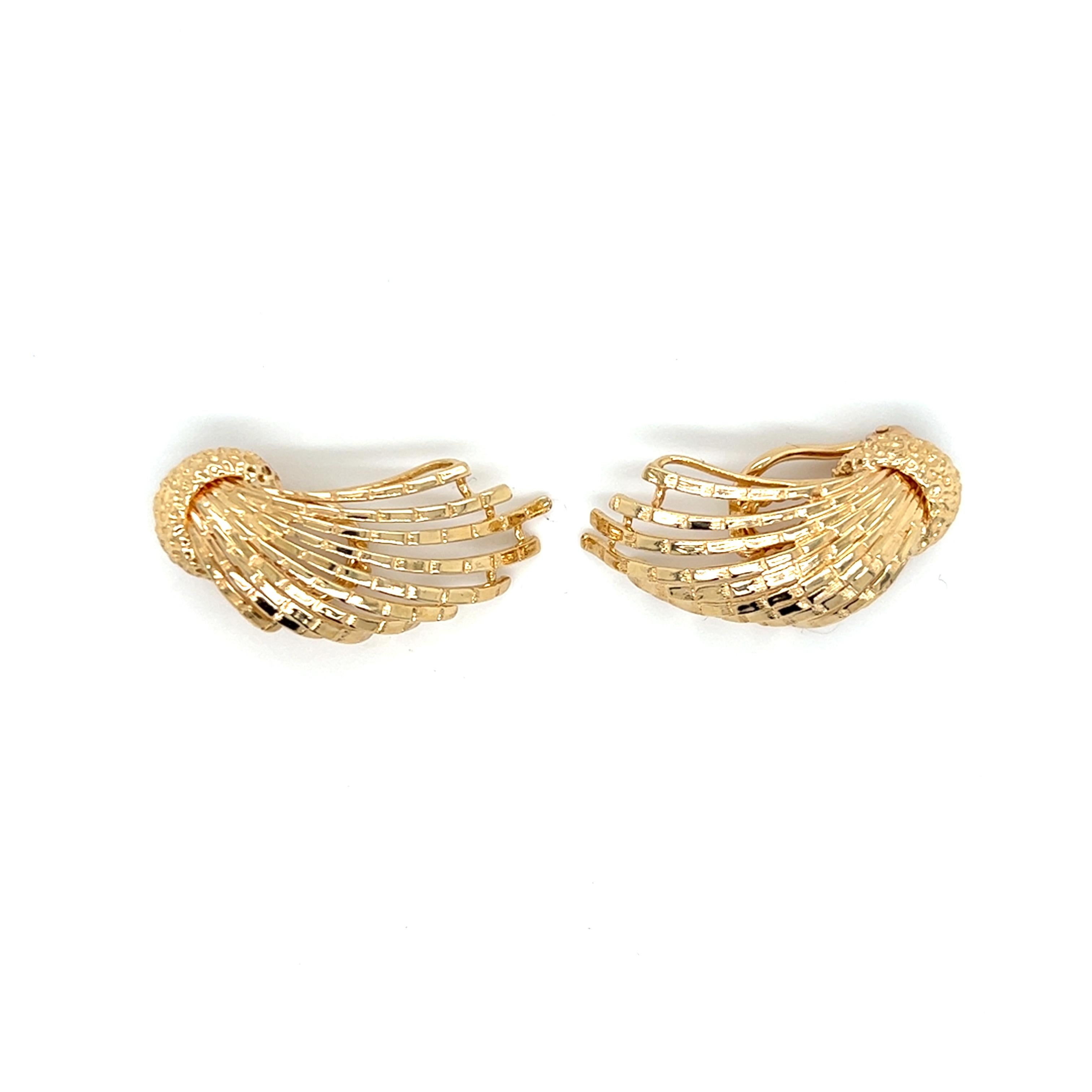 One pair of 14 karat yellow gold spray design clip-on climber earrings by Dan Frere. The earrings are stamped with Dan Frere signature and copyright.  The earrings feature Omega backs, measure 1.25 inches long, and weigh 9.5 grams total weight.  
