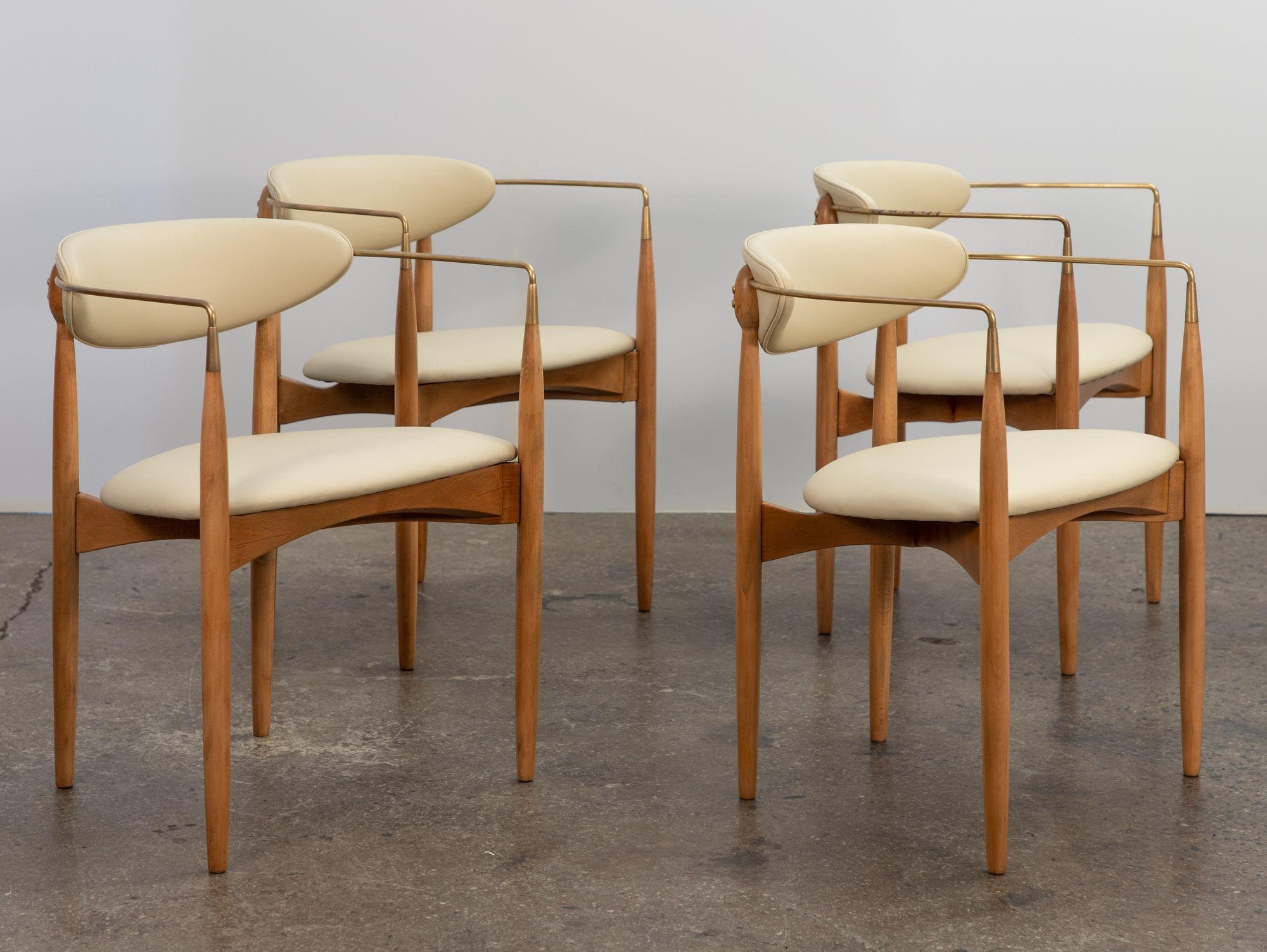 A gorgeous set of dining chairs, designed by Dan Johnson for Selig. Curvilinear form, with sweeping arms made of solid brass. Elegant tapered legs are finely carved from bleached wood. In beautiful condition, these have been restored with great care