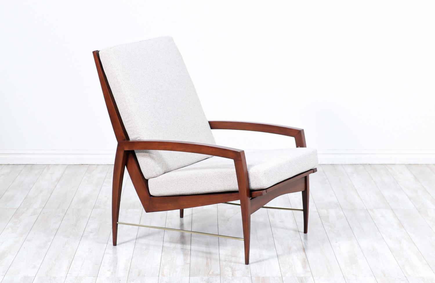 High-Back lounge chair designed by Dan Johnson for Selig and manufactured in Denmark circa 1950’s. Featuring a beautifully carved walnut-stained beechwood frame with five slats accentuating the high-back with curvilinear legs and arms that create an