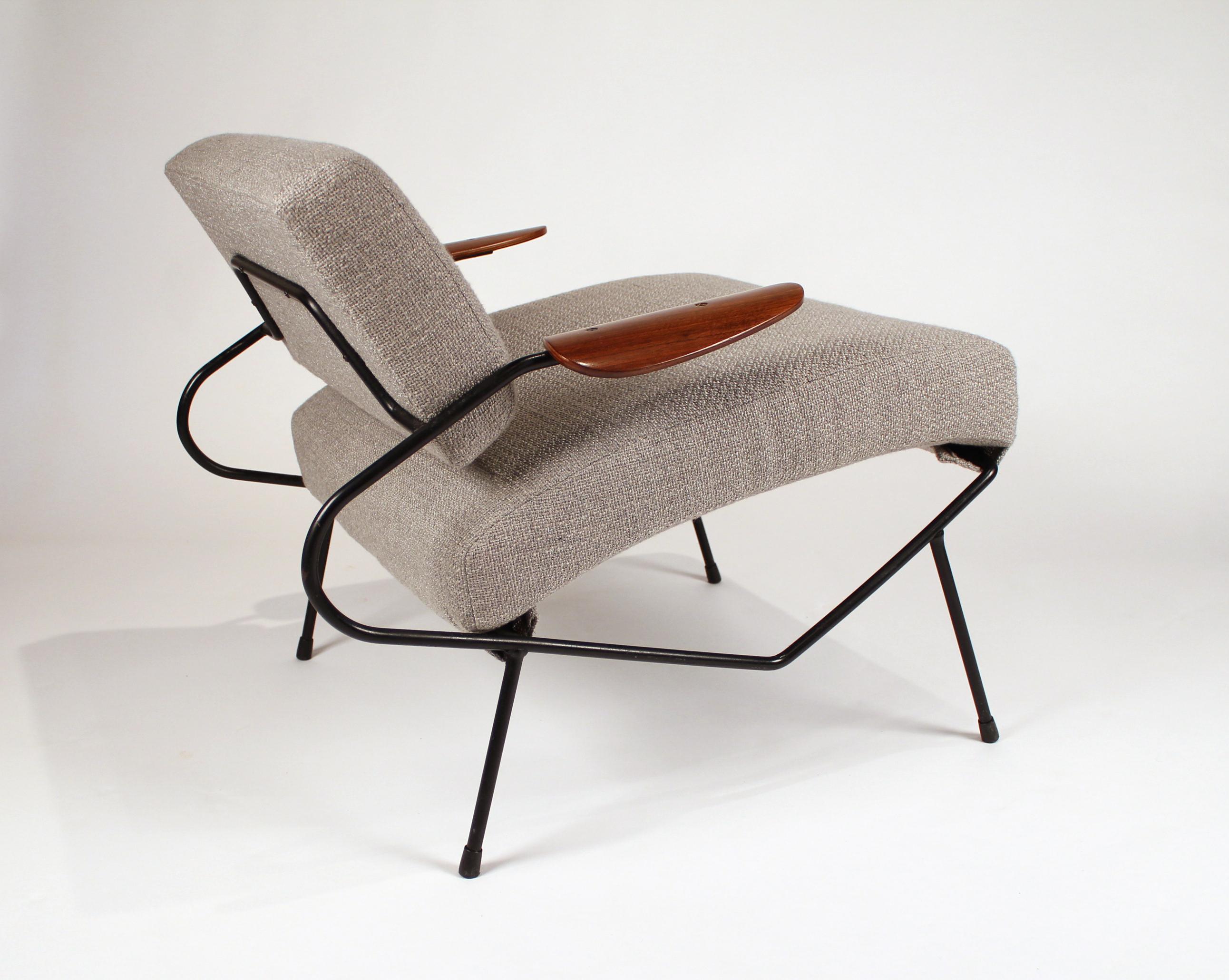 Early Dan Johnson lounge chair with an iron frame and steam bent walnut plywood armrests.