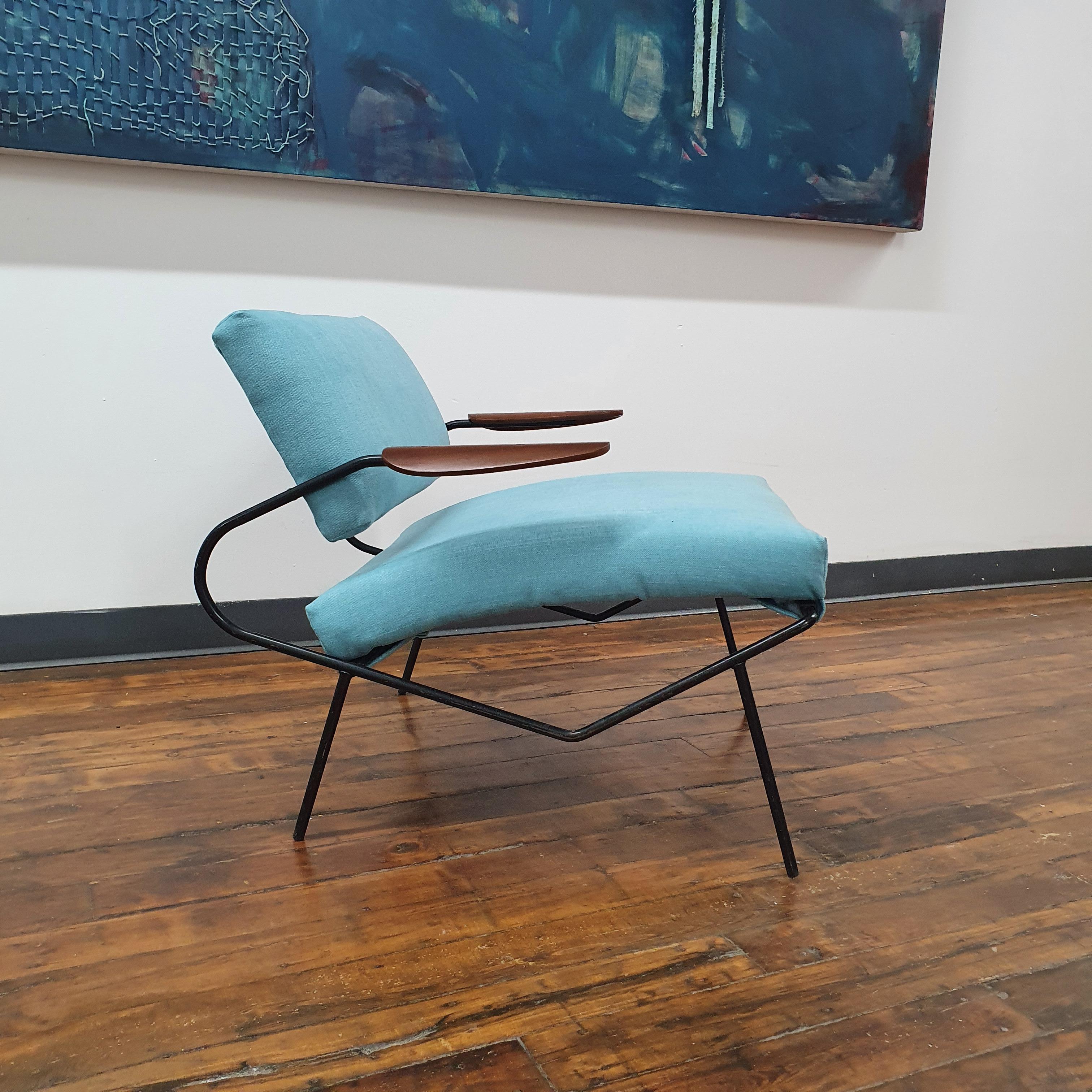 The Iron Lounge Chair with Walnut Armrests by Dan Johnson is a beautiful and unique piece of furniture that combines industrial materials with warm, natural wood. The chair has a sleek and modern design that emphasizes the beauty of the materials