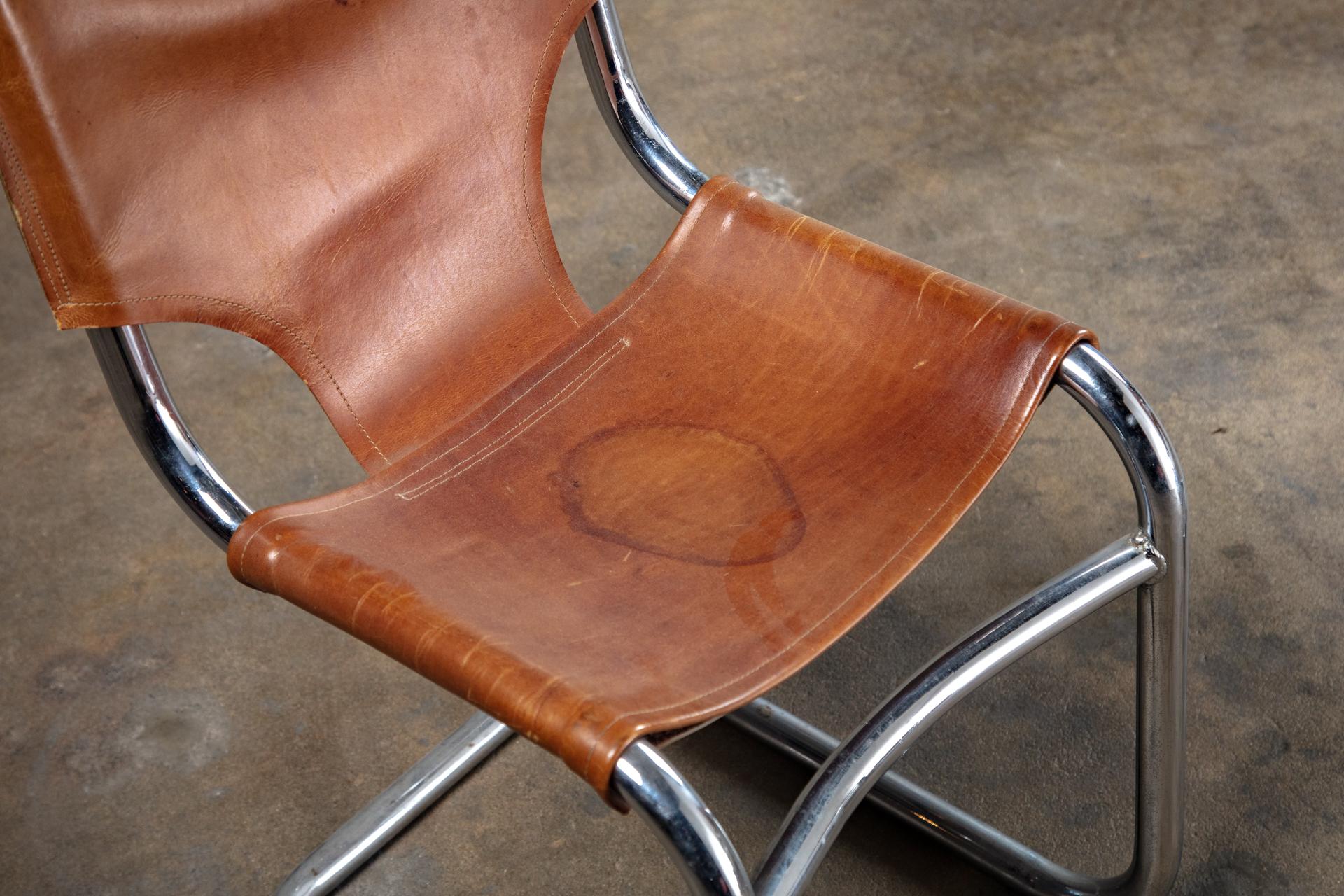 USA: Dan Johnson set of 4 leather and tubular metal chairs, 1950s.