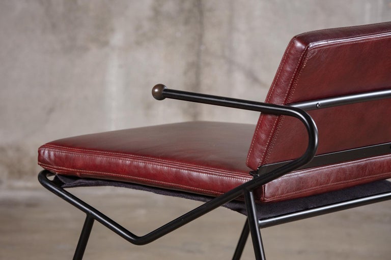 Dan Johnson style armchairs in leather.