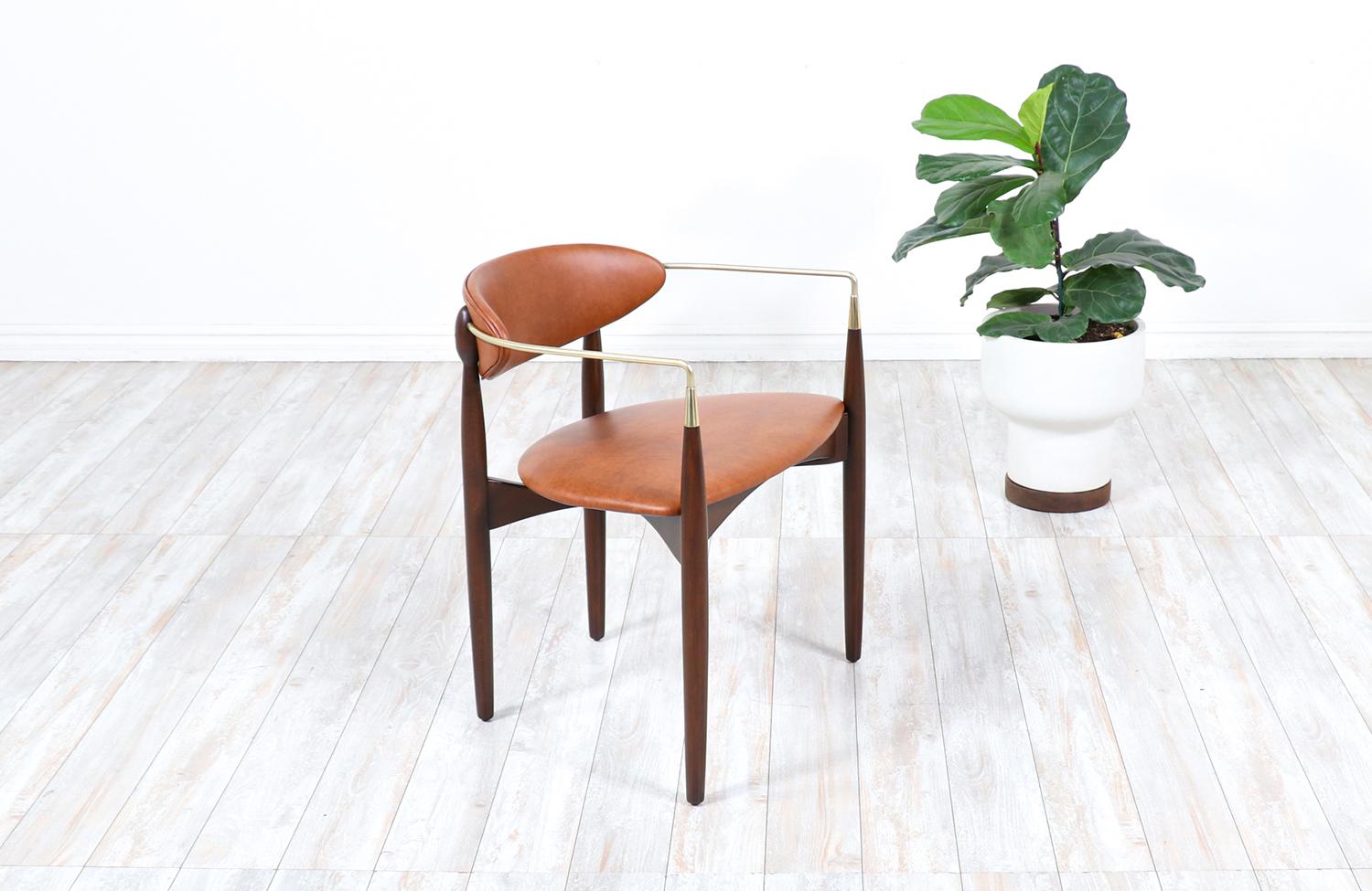 Mid Century Modern “Viscount” armchair designed by Dan Johnson for Selig in Denmark circa 1950’s. This elegant design features a newly refinished walnut wood frame and freshly polished tubular brass arms. The upholstery is new full grain cognac