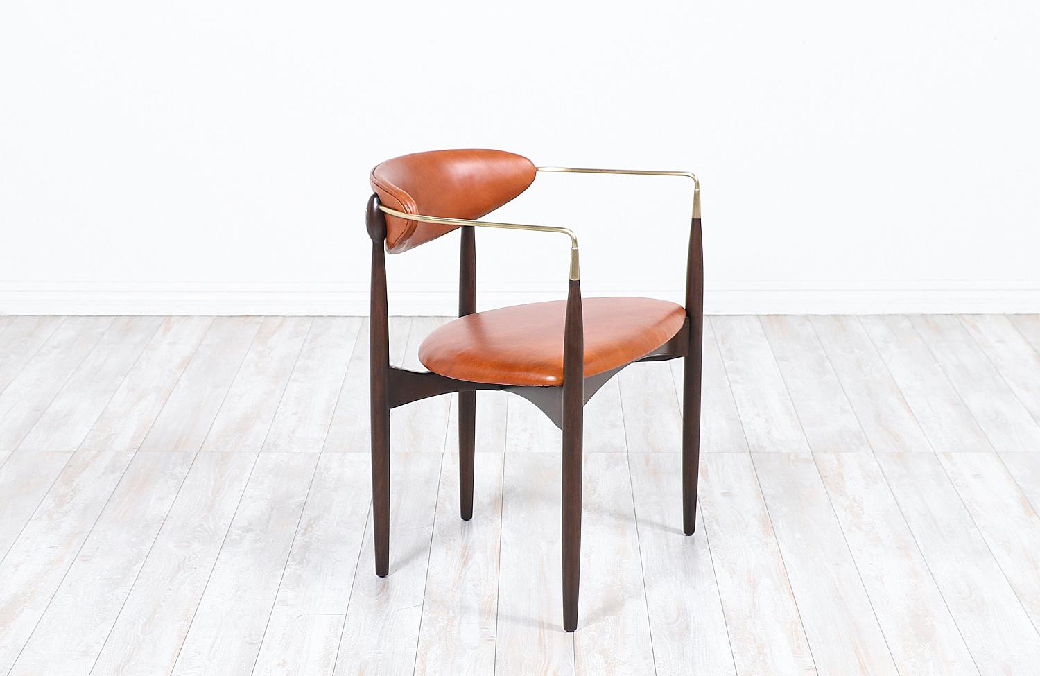 Mid Century Modern “Viscount” armchair designed by Dan Johnson for Selig in Denmark circa 1950’s. This elegant design features a newly refinished walnut wood frame and freshly polished tubular brass arms. The upholstery is new full grain cognac