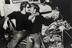 Mugging, black and white photograph of two men kissing by Dan Nelken