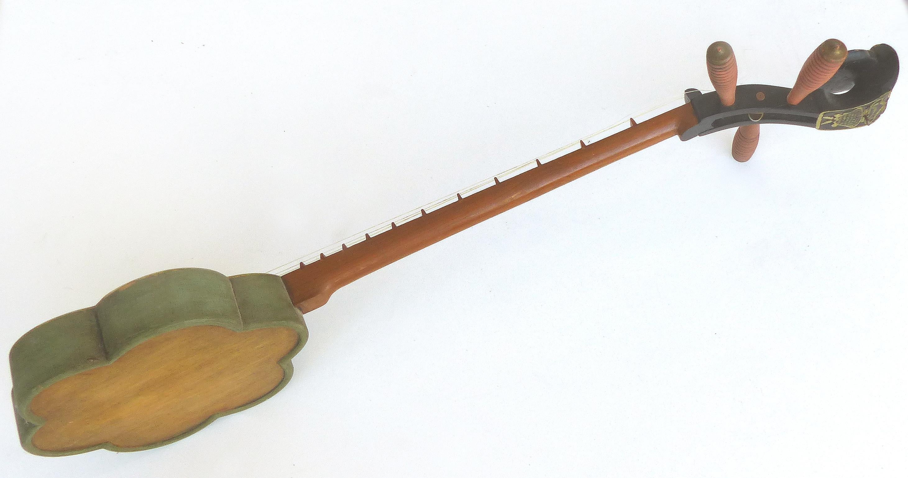 Dan Sen 3-String Flower Lute Instrument for Display

A Dan Sen 3-string lute with a flower form body. Originating in Vietnam, the Dan Sen is also known as the moon lute or moon guitar. The tuning keys are adorned with an ornately carved head. A