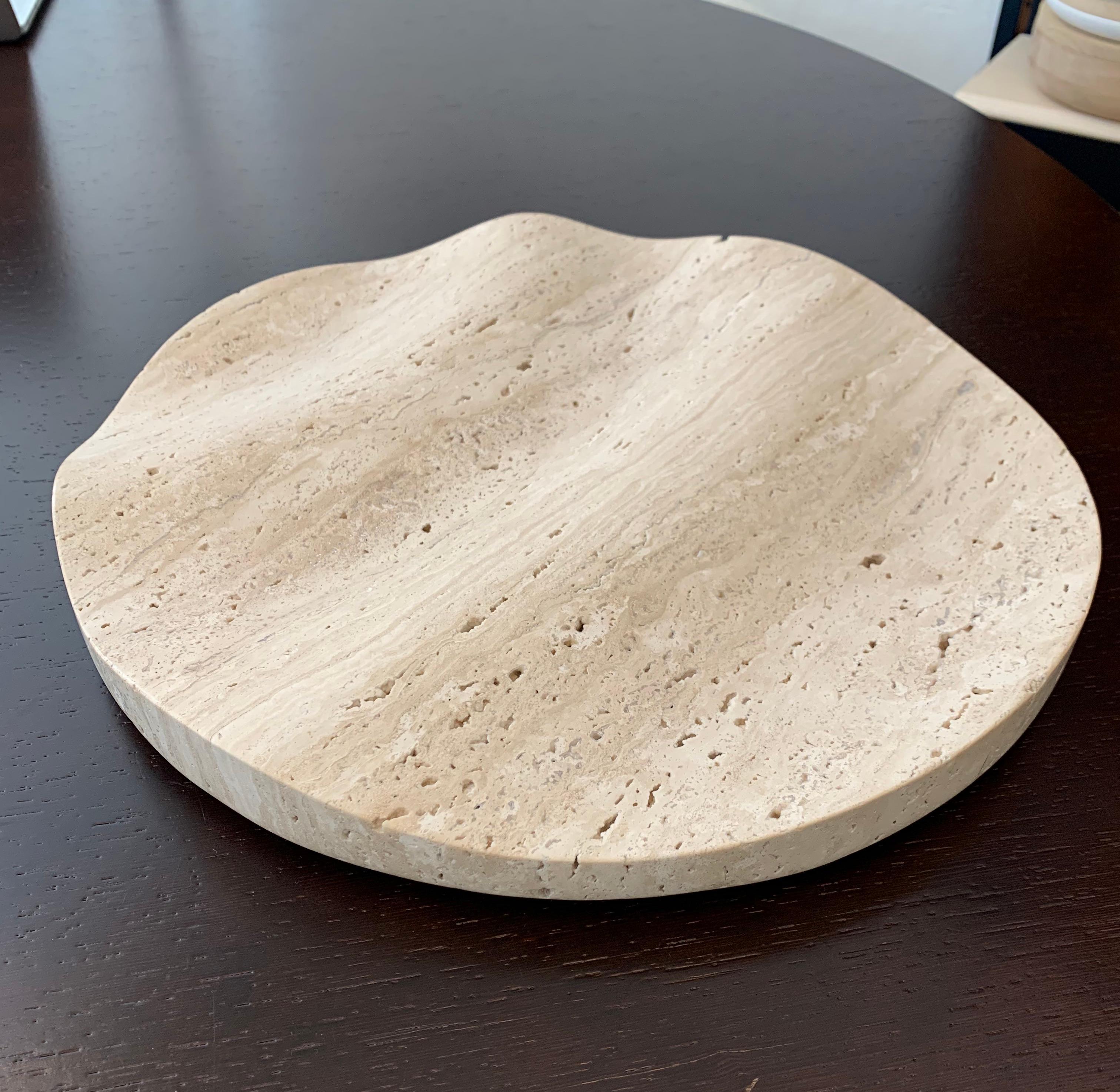 'Ripple' fruit bowl / centre piece by French renown French designer Dan Yeffet. 
Yeffet has taken an everyday object and elevated into a work of extraordinary beauty. 
This beautiful solid bowl, cut from solid travertine, features intriguing