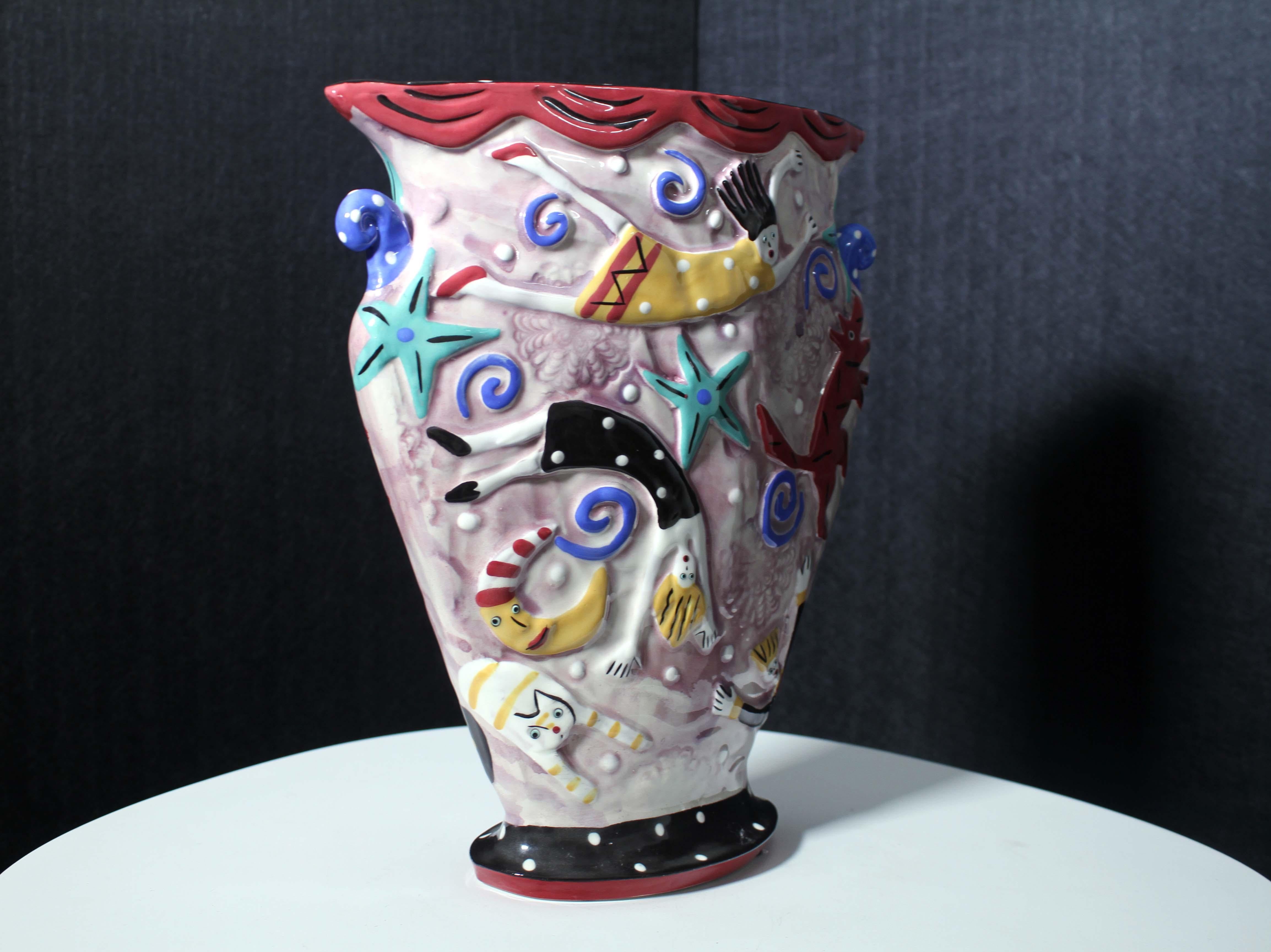 A folk art inspired handmade built slab ceramic vase titled “In My Dreams We Fly” by Dana Simson of Chesapeake East. A unique composition with floating figures, animals, and celestial designs. Stamped on the bottom. Created in 2001. Adds an element