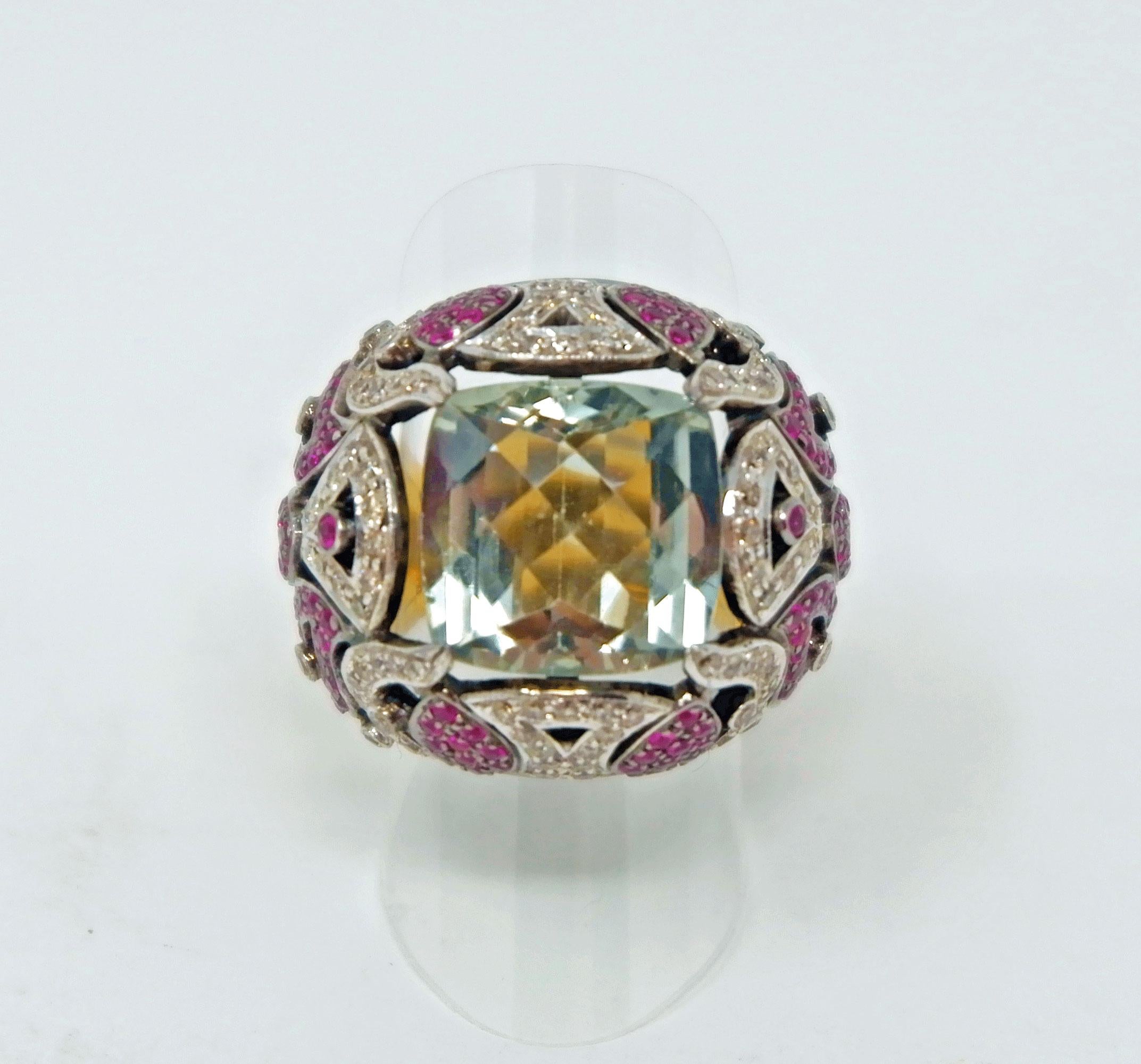 Spectacular ring featuring a large square cut, faceted green amethyst. The amethyst is surrounded by diamonds and hot pink sapphires set in silver in a paisley pattern. The bottom half of the ring is gold plated on silver. This is a unique piece of