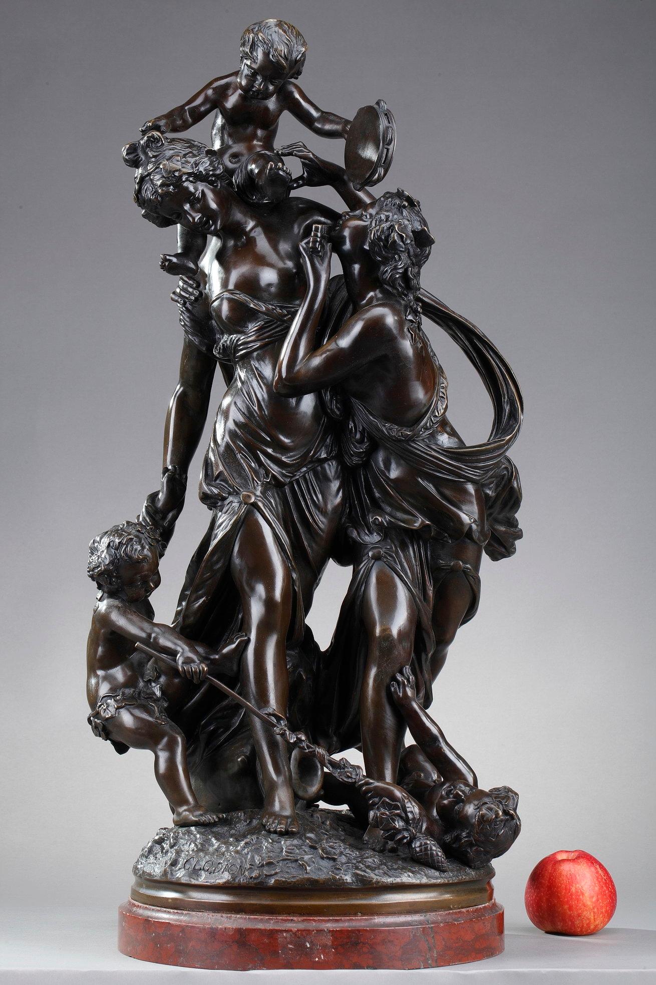 Large bronze group with brown patina after Claude Michel, called Clodion (French, 1738-1814). The statuette features two young bacchantes and three putti. The bacchantes are crowned with vine leaves and wear flowing dresses in antique style. One of