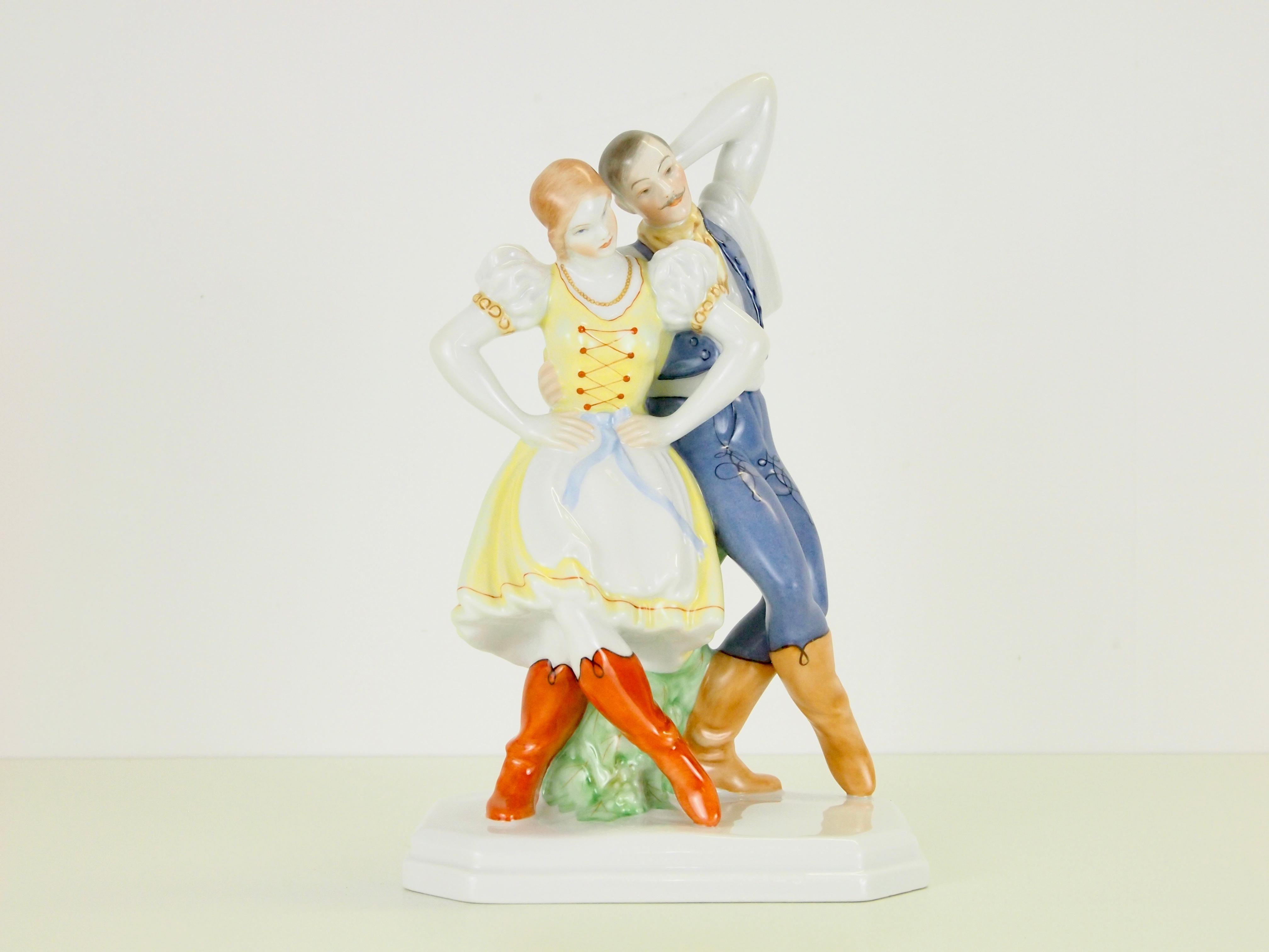 Delicate vintage porcelain statuette depicting a romantic dancing couple manufactured by Herend Hungary.

Herend was founded in 1826 and has had much famous customers who bought it's porcelain. At the first World's Fair the porcelain manufacturer