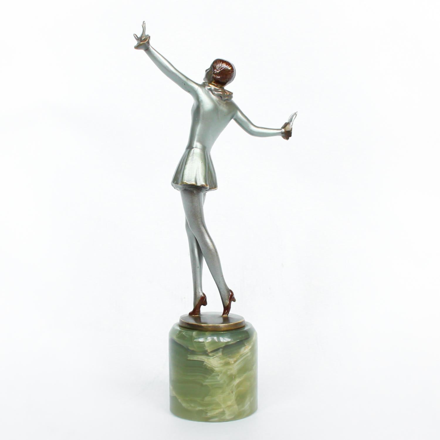 An Art Deco, cold painted bronze figure of an elegant dancer in a striking pose, raised on a green onyx base.

Signed Lorenzl to bronze.



