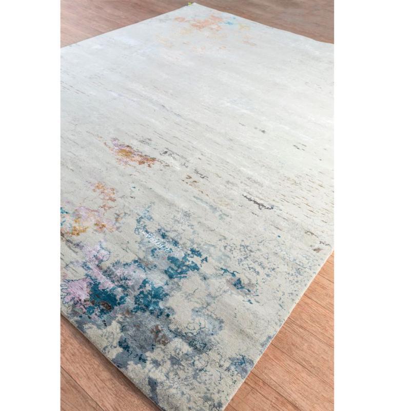 Transport yourself on a mesmerizing visual odyssey with our hand-crafted rug, each thread spinning a tale of skill and precision. Like strokes on a canvas, the antique white backdrop intertwines with light rust borders, creating an exquisite design