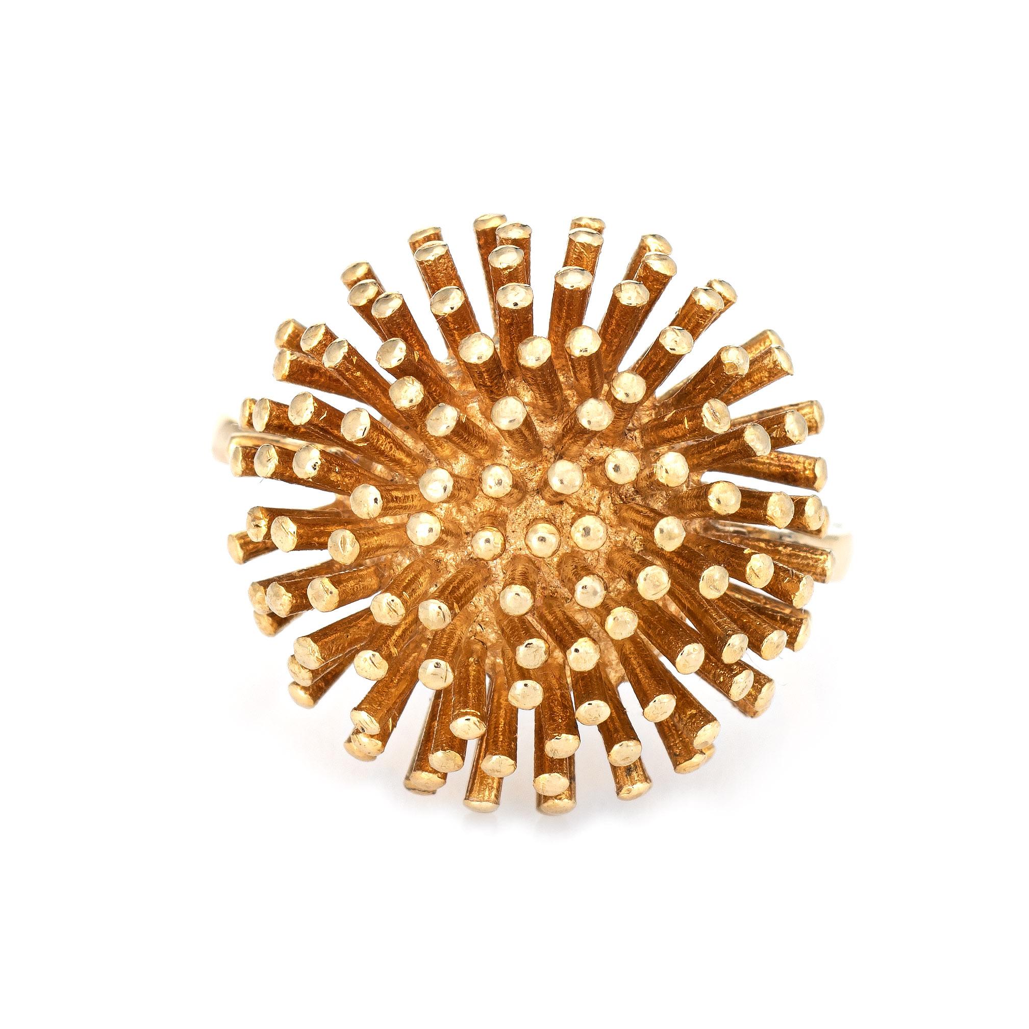 Stylish dandelion ring crafted in 18k yellow gold (circa 1980s to 1990s). 

The distinct ring features an array of gold points arranged in the form of a dandelion. The domed ring makes a great statement on the hand. The medium rise ring (9.5mm -