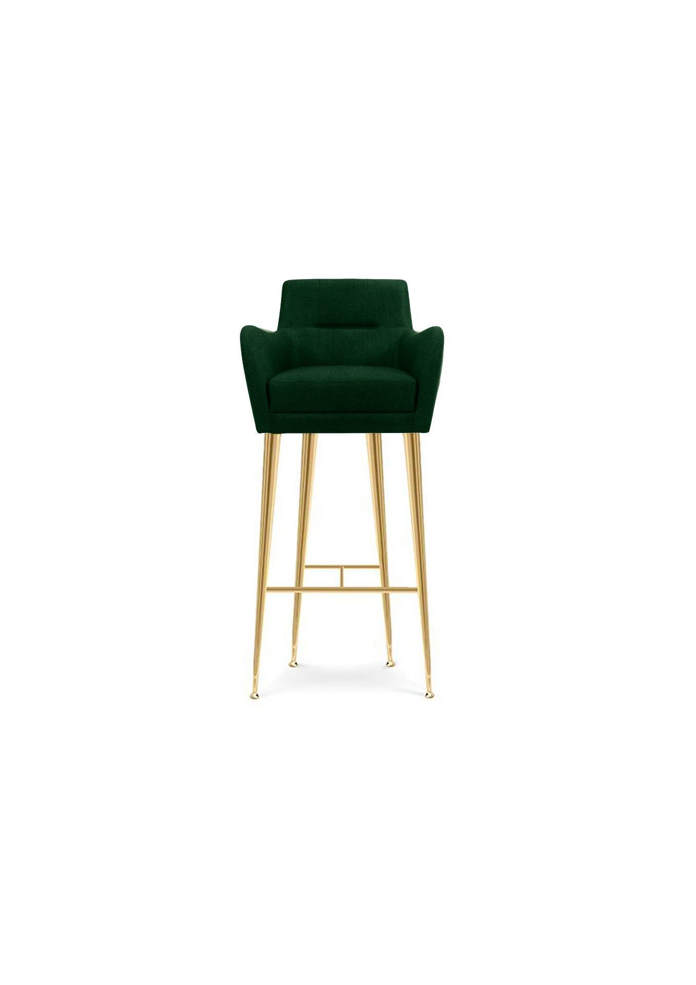 Dandridge bar chair is part of a bigger collection, matching an armchair and a sofa. It has a low back and accent sloping arms, that makes it more confortable than a counter stool. The long tapered polished brass legs give it a sensual and slim