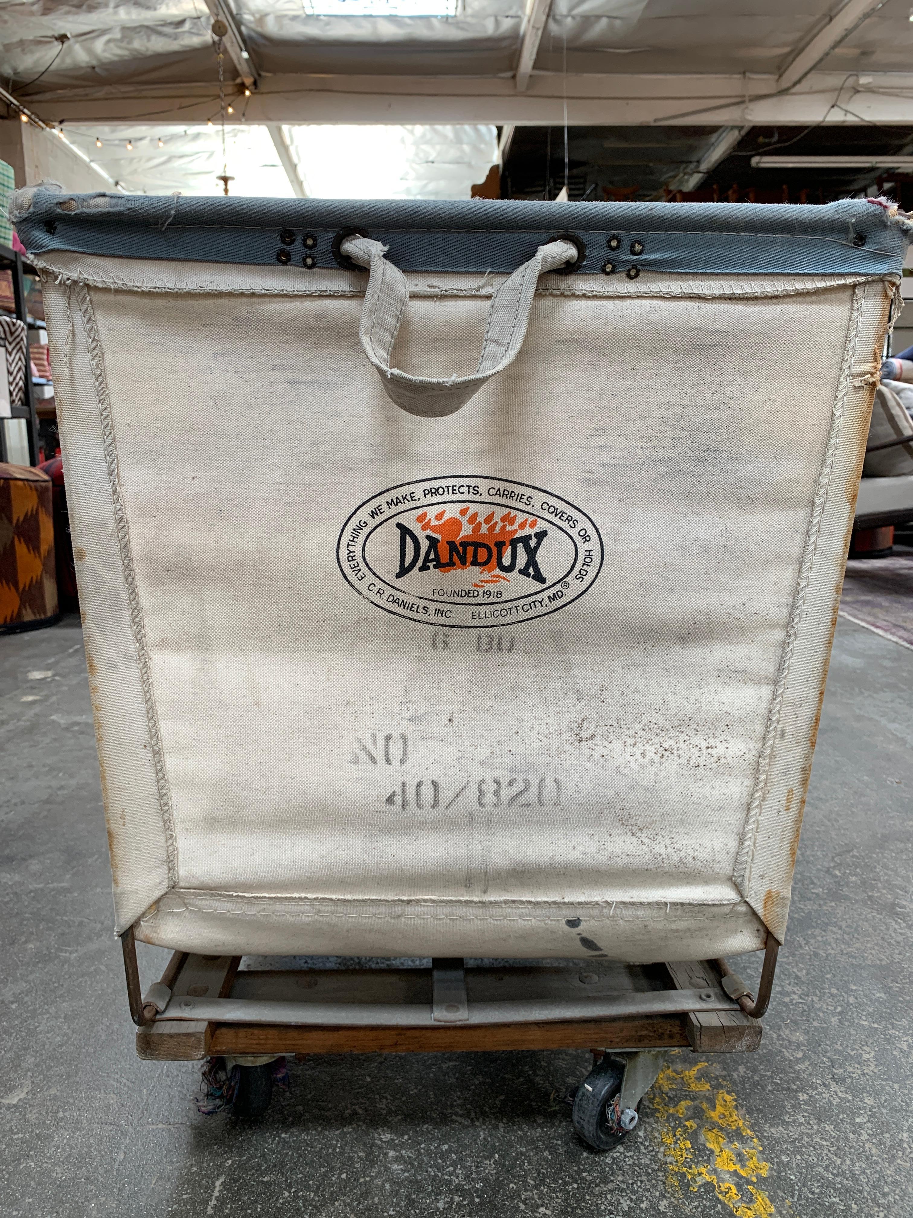 This blast from the past vintage rolling canvas laundry basket is straight out of a production of Annie. A perfect prop, historical industrial piece or accent basket for blankets or pillows.