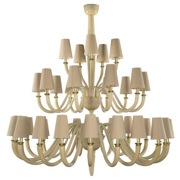 This superb chandelier is a perfect example of harmonious combination of traditional craftsmanship and contemporary design. This piece is made of mouth-blown Murano glass and its three-tier structure is a modern interpretation of a traditional