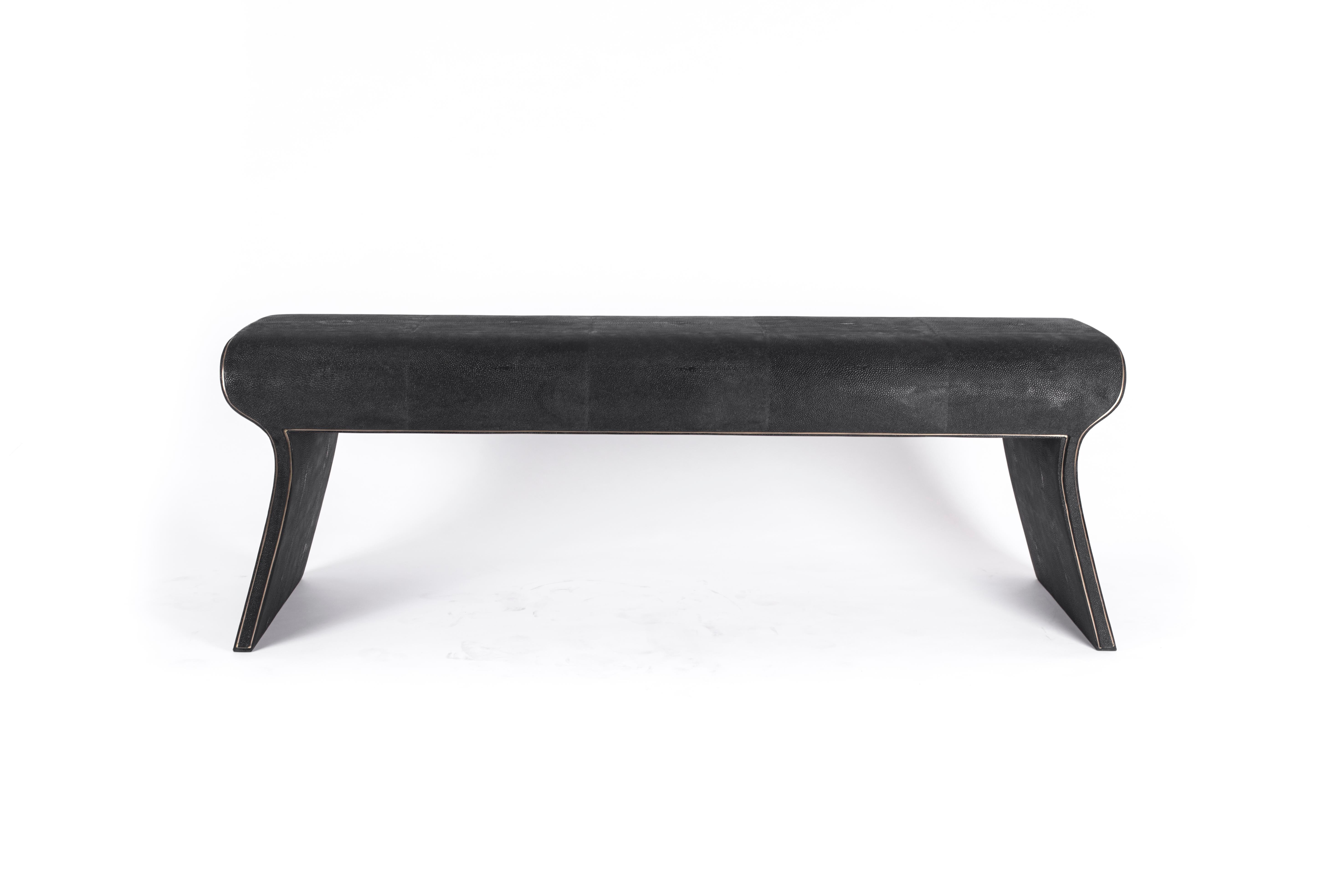 The Dandy day bench is the ultimate luxury seating. Completely covered in coal black shagreen except for a subtle metal inset frame around the bench that adds another dimension to the piece. Upholstery available on request. This piece is designed by