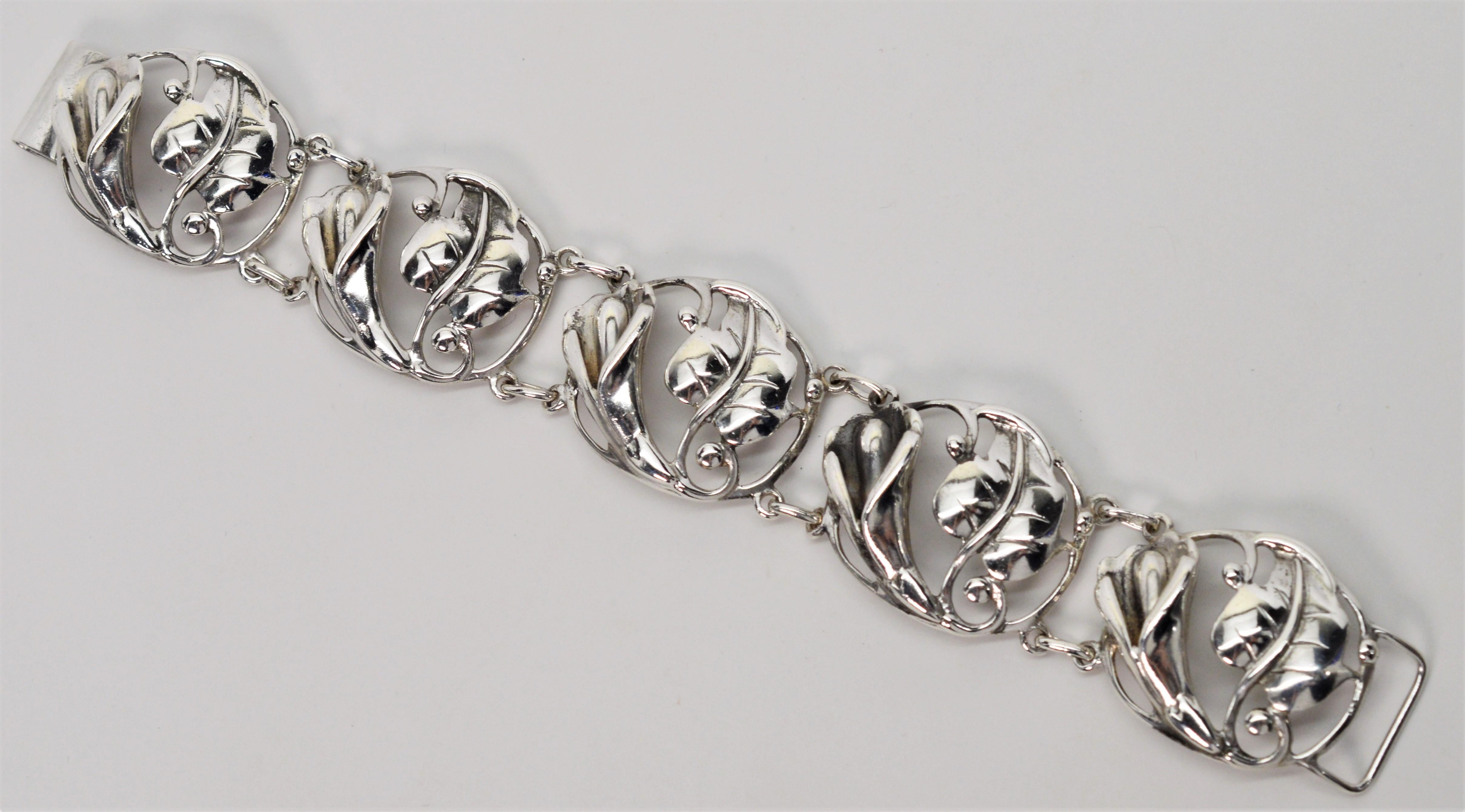 Vintage and stamped by the maker, this attractive timeless sterling silver bracelet displays five round crafted links of pretty lilies and leaves creating
a pleasing, well constructed piece, perfect for silver lovers. Bracelet measures 7-1/2 inches