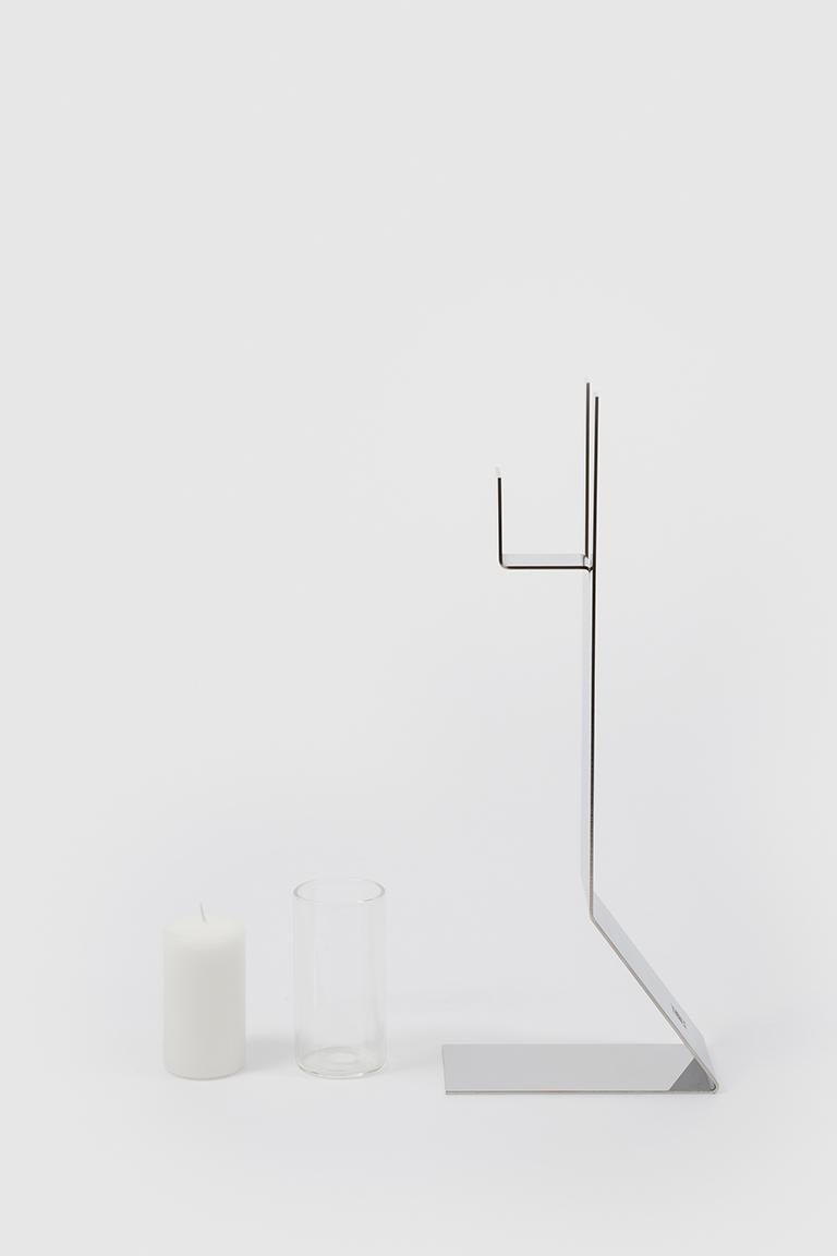 Panarea is a candle holder that with its lightness, simplicity and intelligent design makes the most of the materials and technology used to make it. A Pyrex cylinder that contains the candle and protects the flame I inserted into a bent sheet of