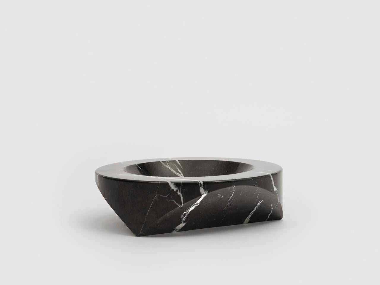 Paros D1 is an ashtray that can also be used as a table centrepiece. It is made from a section of a simple cylinder of semi-finished black Marquina marble and is produced in a limited edition of 100 pieces per year.

Enzo Mari is one of the