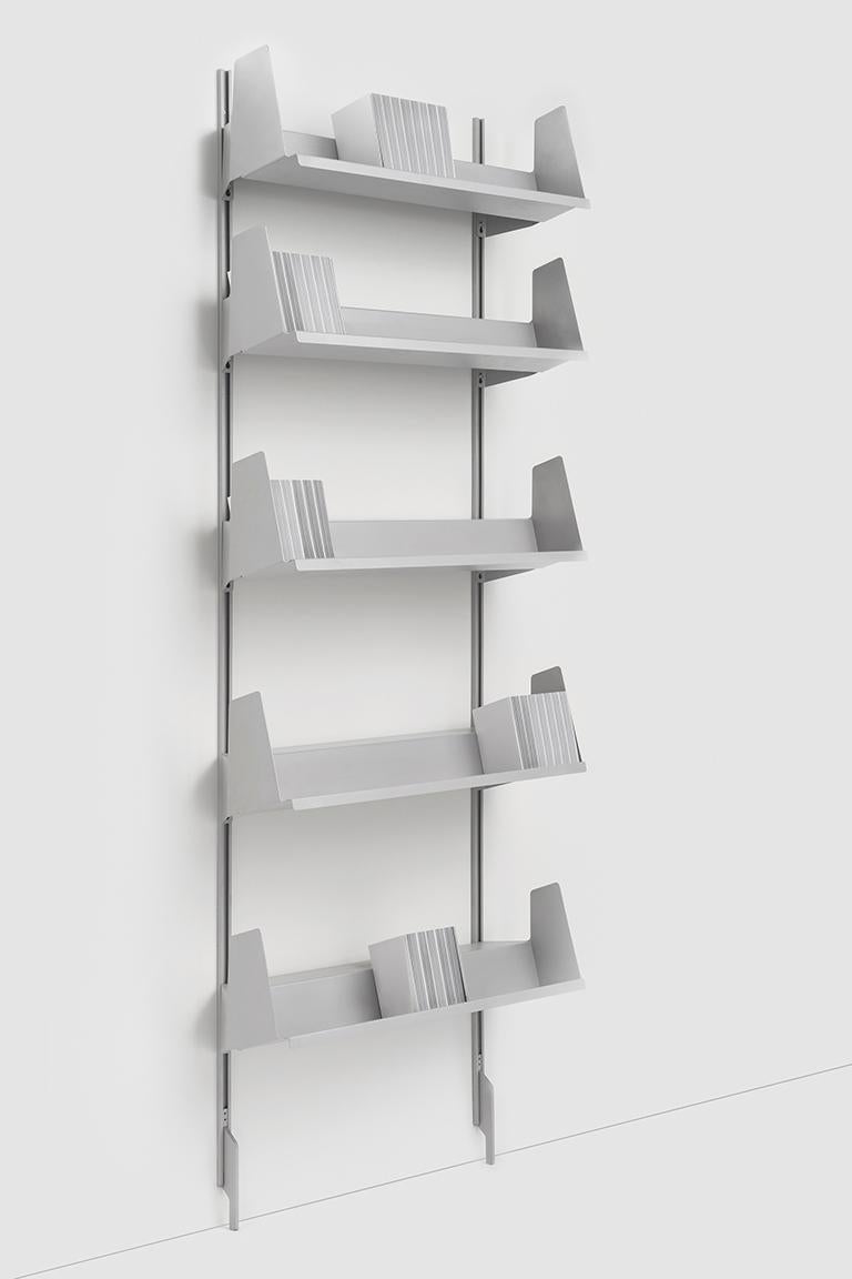 Sarmiento brings together both technological and conceptual innovation into one wall-mounted bookcase with tilted shelves. Although the structure is minimal it provides a myriad of possibilities. The shelves slide up and down the wall uprights