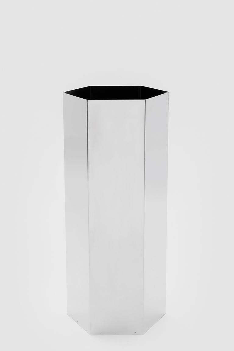 Sicilia 56 is a cylinder with a hexagonal base and the function of umbrella stand. The structure is made of polished stainless steel.

Bruno Munari was one of the most important Italian architects, artists and designers of the 20th Century. Born