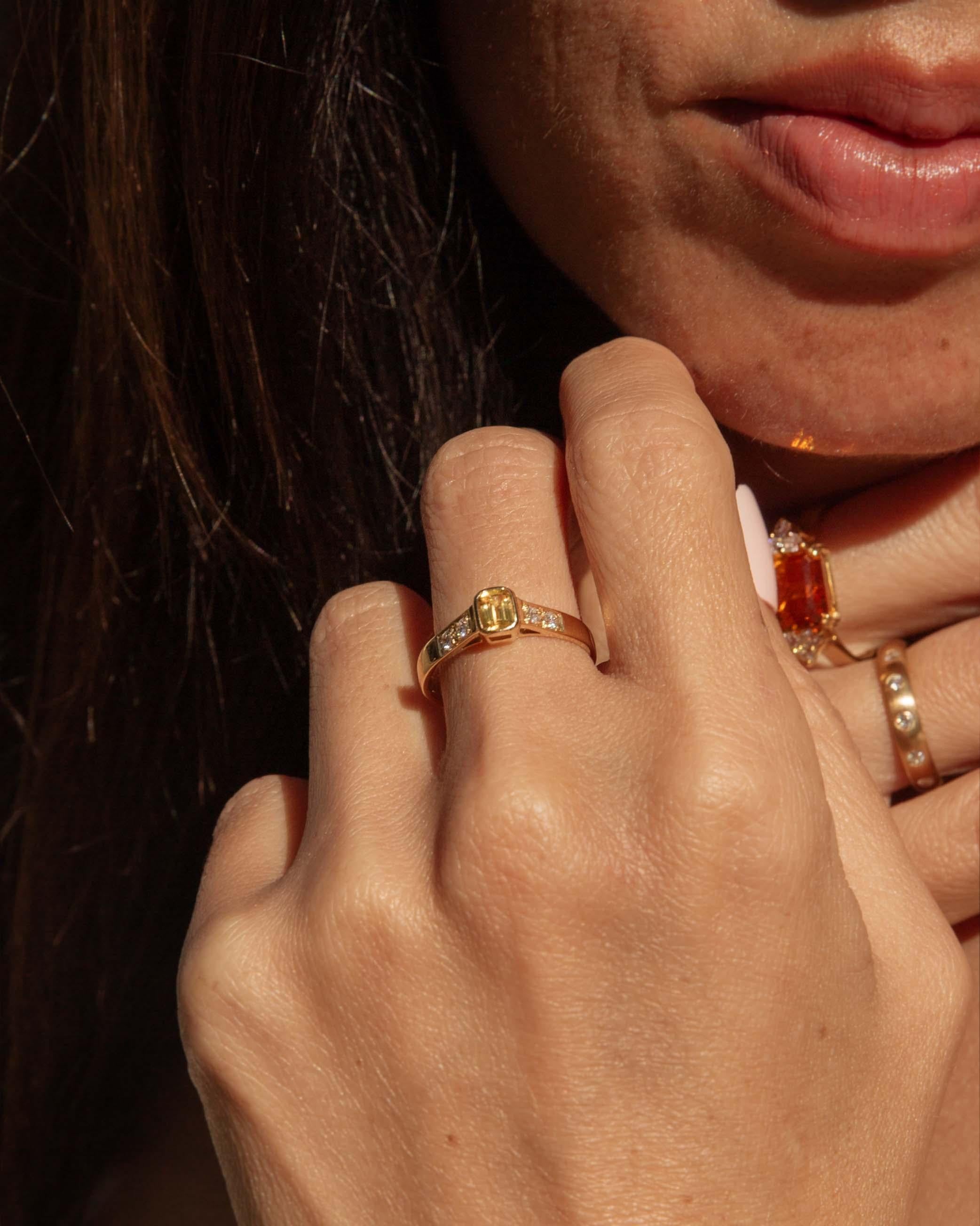 Enchanting and radiant, the 18ct gold Danette ring captures the essence of timeless elegance, showcasing a luminous yellow sapphire surrounded by a halo of sparkling diamonds. This exquisite piece whispers tales of the past while embodying the