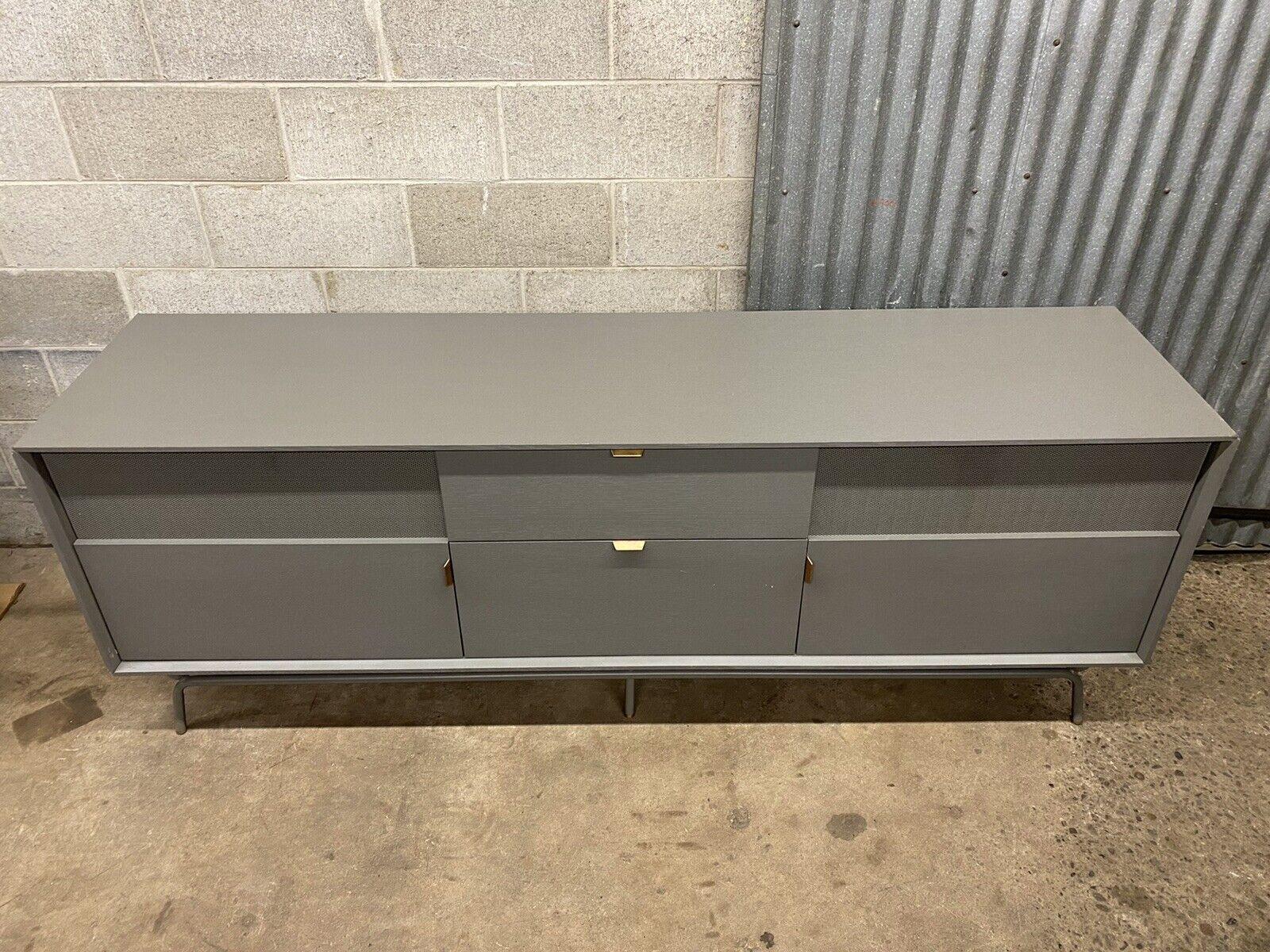 Dang 2 door 2 drawer grey media stand console credenza by Blu Dot. Item features perforated steel door fronts, steel metal base, brass details, original papers, very nice item, clean modernist lines, great style and form, retail price $2,750. Circa