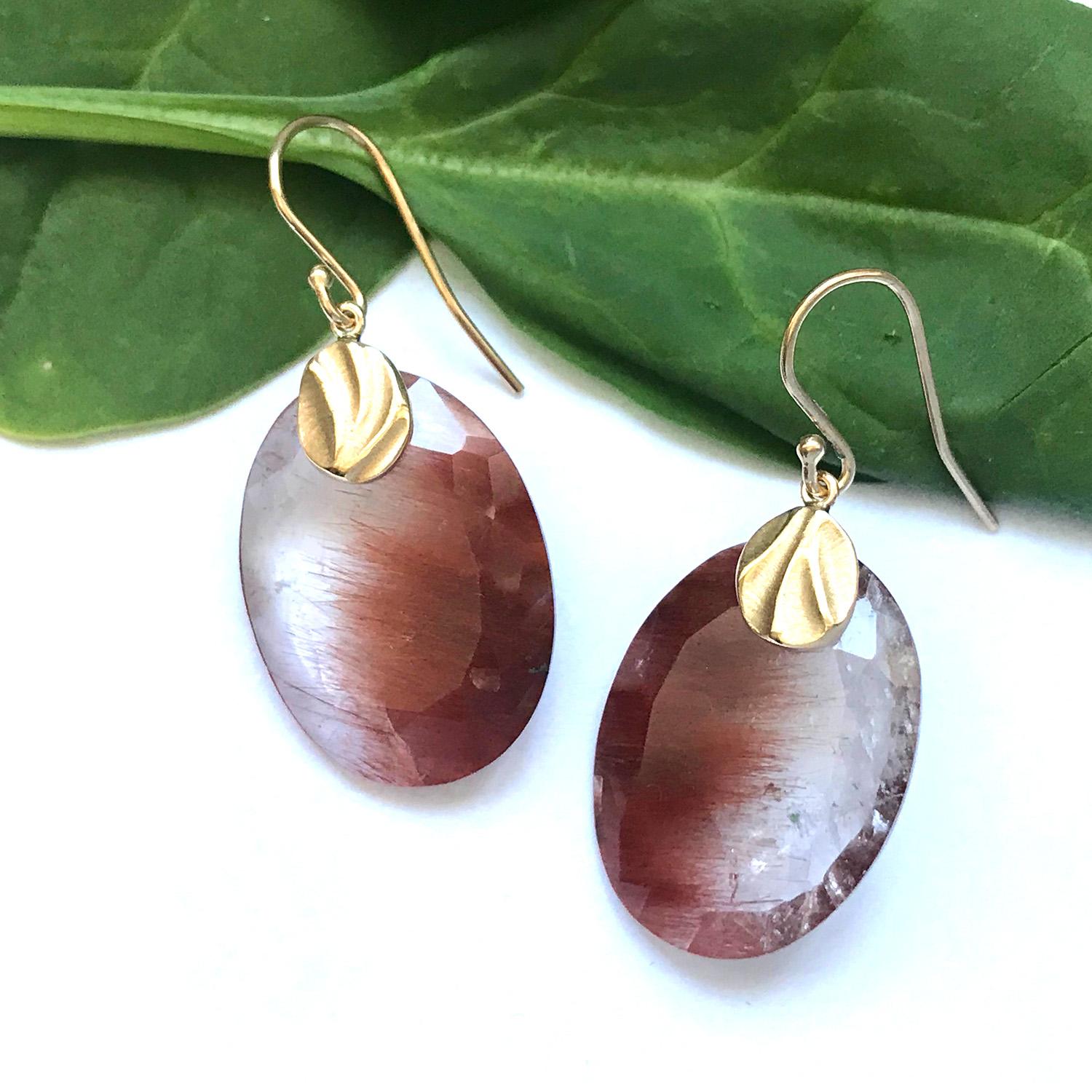 Stunning red rutilated quartz (29.27ct total weight) shaped like oval pebbles are the heart of K.Mita’s Oval Pebble Earrings. The long needle-like threads of rutile floating in the quartz are said to promote healing and to combat negative energy.