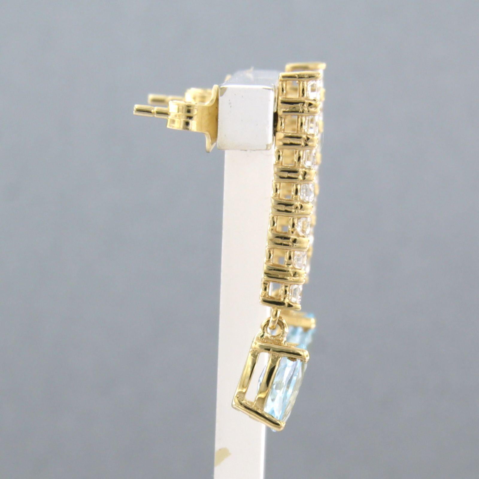 18k yellow gold earrings set with topaz and brilliant cut diamonds up to approx. 0.58 ct - F/G - VS/SI

detailed description:

the size of the earring is 2.7 cm high and 5.0 mm wide

Total weight 3.7 grams

set with

- 2 x 7.0 mm x 5.0 mm oval facet