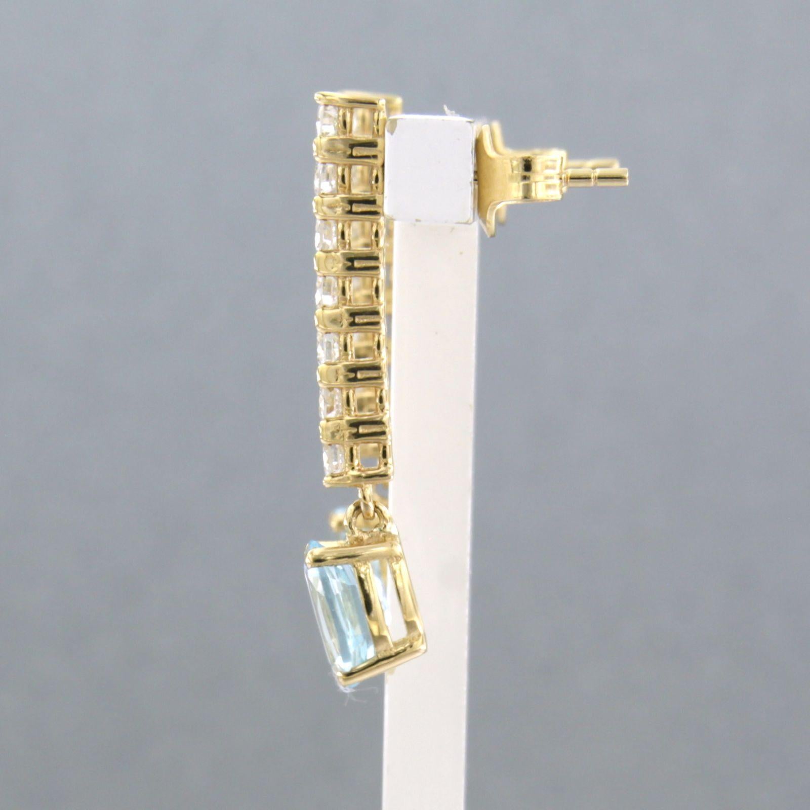 Modern Dangle earrings with blue topaz and brilliant cut diamonds up to 0.58ct 18k gold For Sale