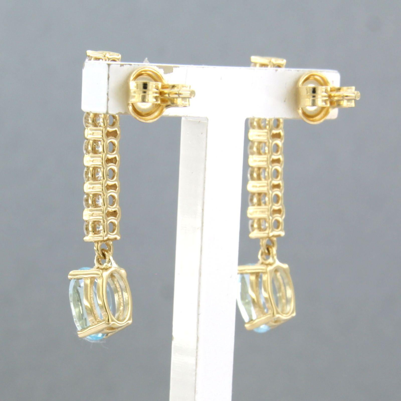 Brilliant Cut Dangle earrings with blue topaz and brilliant cut diamonds up to 0.58ct 18k gold For Sale