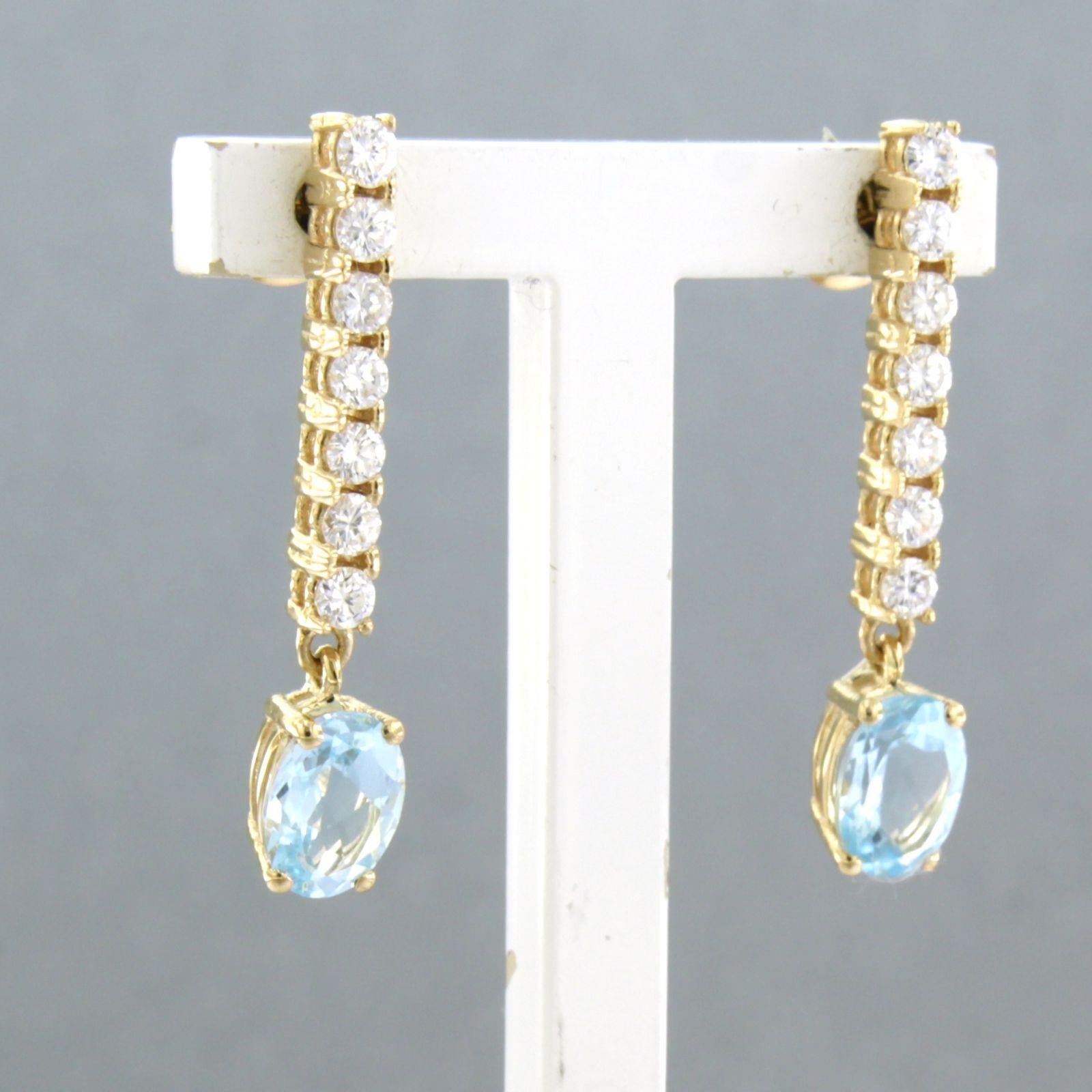 Women's Dangle earrings with blue topaz and brilliant cut diamonds up to 0.58ct 18k gold For Sale