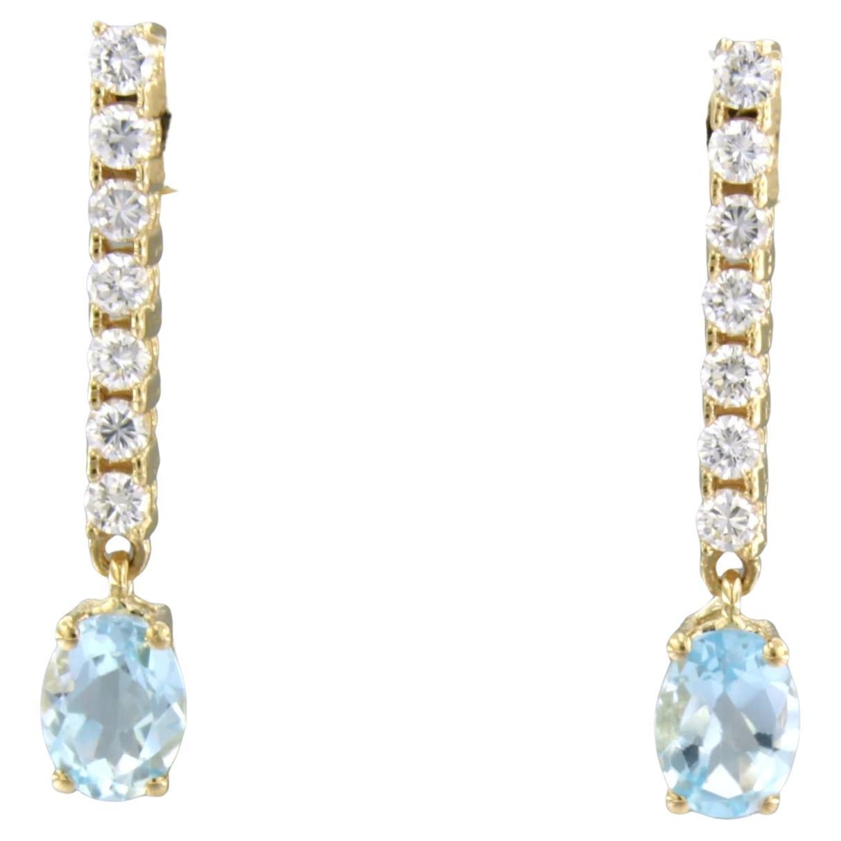 Dangle earrings with blue topaz and brilliant cut diamonds up to 0.58ct 18k gold