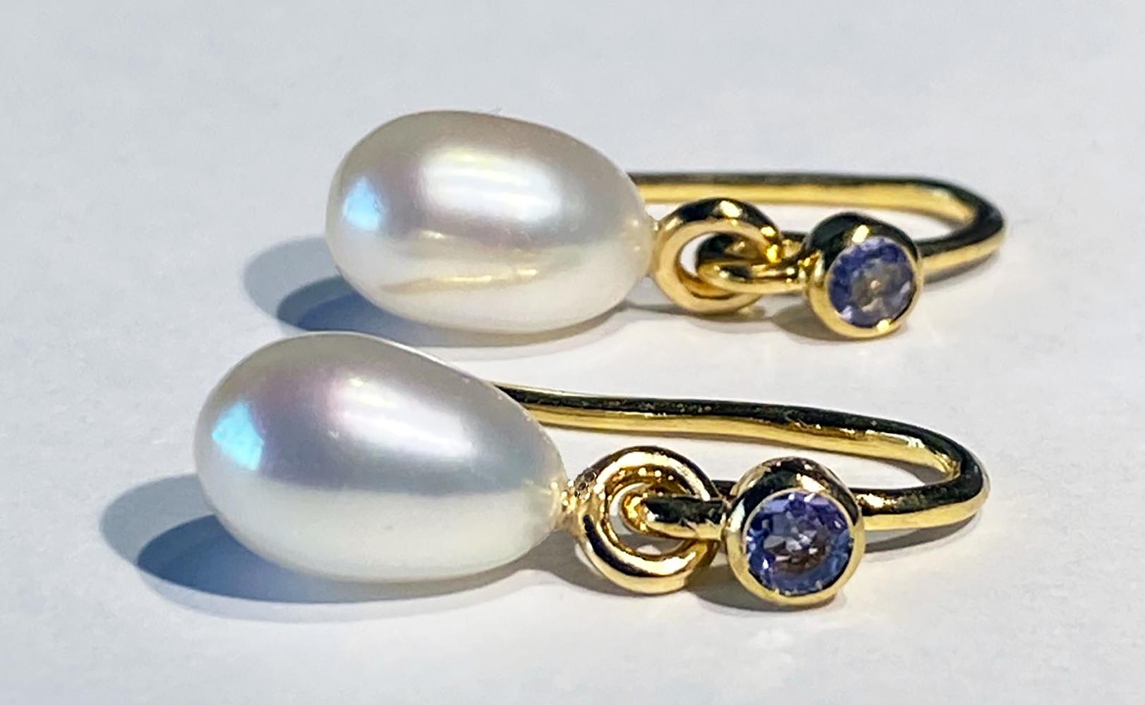 A pair of Kary Adam Designed, 14kt Gold & Silver Pearl Dangle Earrings with Tanzanite Accents. 

Originally from San Diego, California, Kary Adam lived in the “Gem Capital of the World” - Bangkok, Thailand, sourcing local gem stones and working with