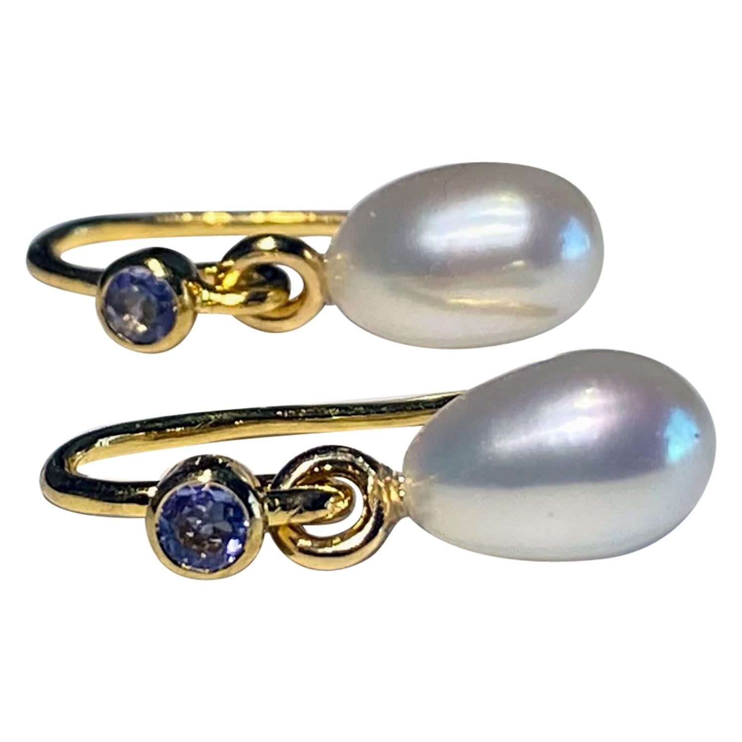 A Pair of Pearl Dangle Earrings Accented with Tanzanites.