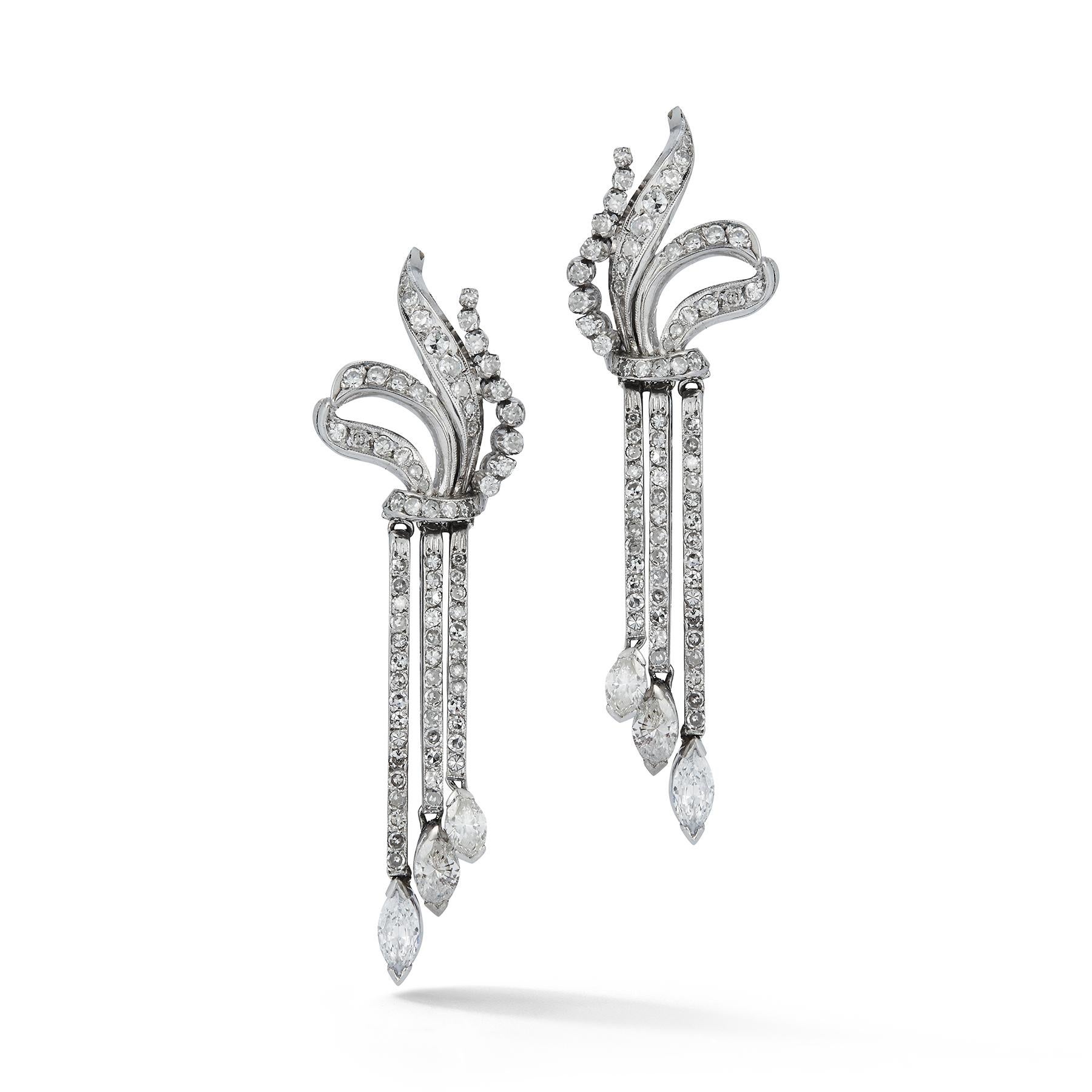 Dangling Diamond Earrings
Set with round cut diamonds & 3 marquise cut diamonds hanging. Total carat weight approximately 5.50 cts all set in 18k white gold

Measurements: 2.25