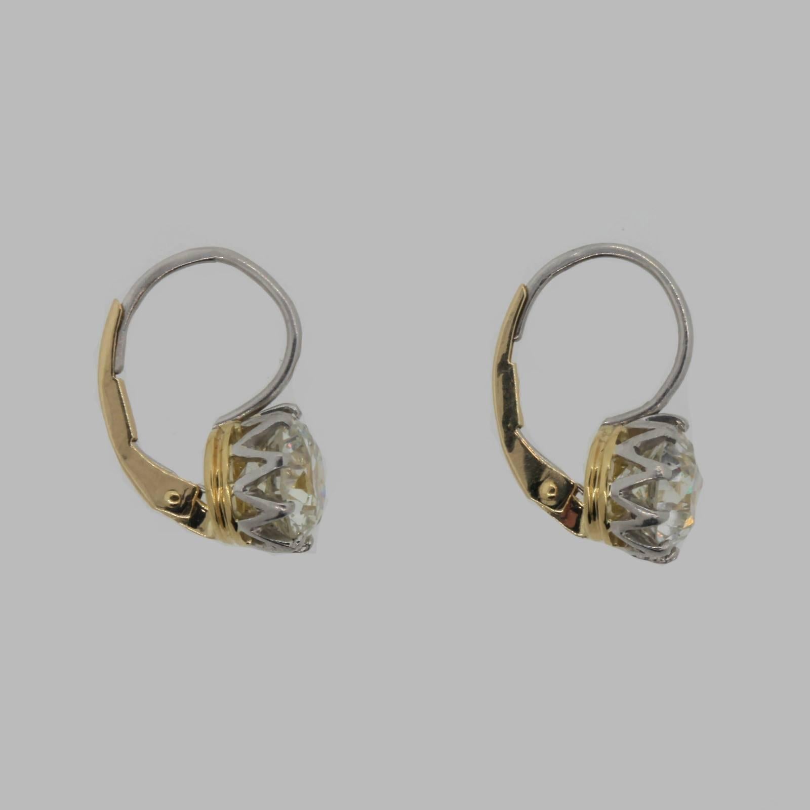 Brilliant Dangling Diamonds Studs!  This handmade earrings are fabricated in platinum and 18KT yellow gold, Victorian style crown setting.  Each earring is set with certified Old European Cut Diamonds.  One weighs 1.44 carat of J color - SI2 clarity
