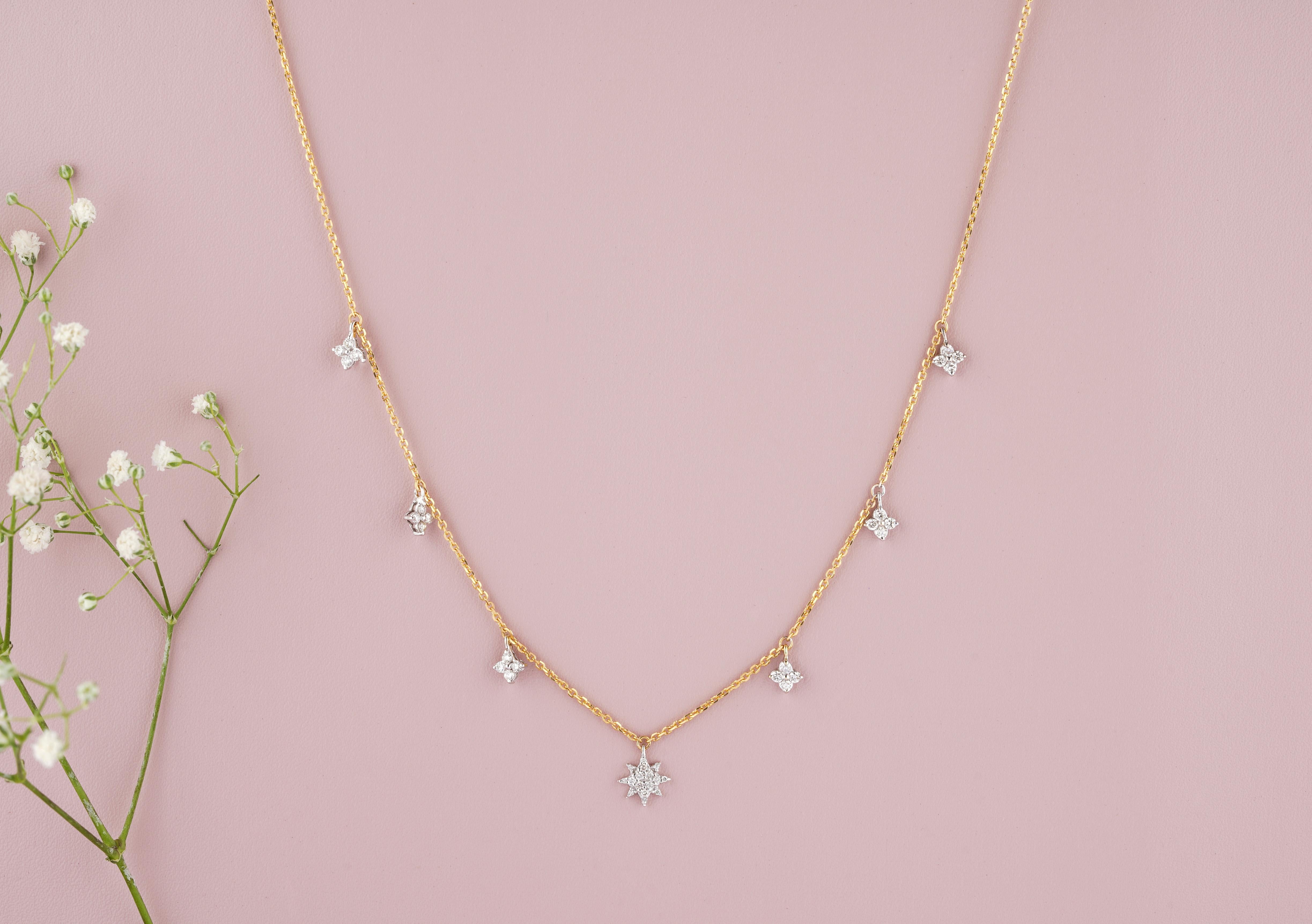 This Dangling Diamond Stars Charm Necklace in 18k Solid Gold is an elegant and stylish piece of jewelry. Crafted in solid 18k gold, this necklace features delicate star-shaped charms adorned with shimmering diamonds. The stars are designed to dangle