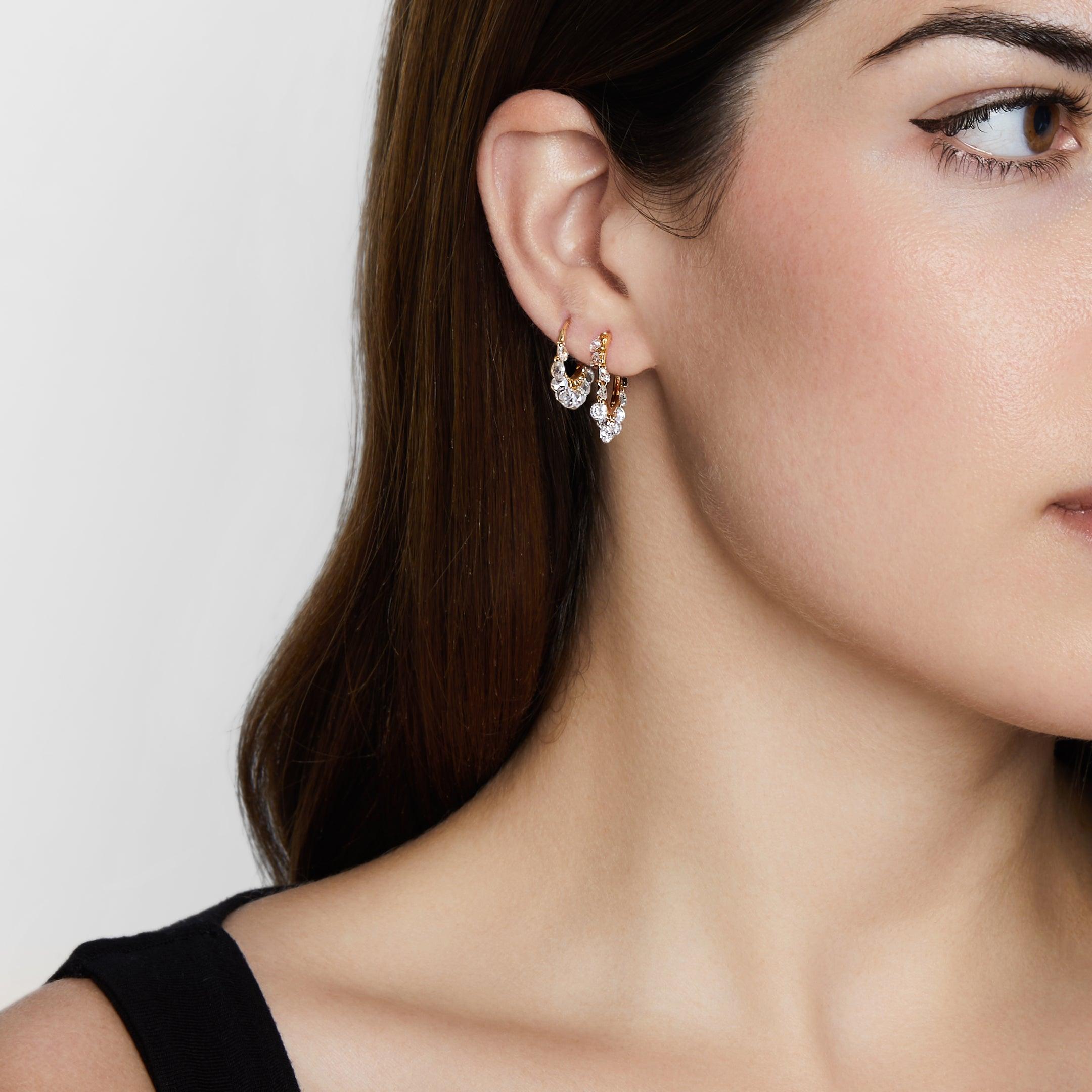 Minimal 18-karat yellow gold huggie hoop earrings get a glamorous upgrade in our Dangling Diamond Hoops. Glittering pear-shaped rose-cut diamonds sparkle and move with every turn of the head. They’re the perfect update to your preferred hoops or