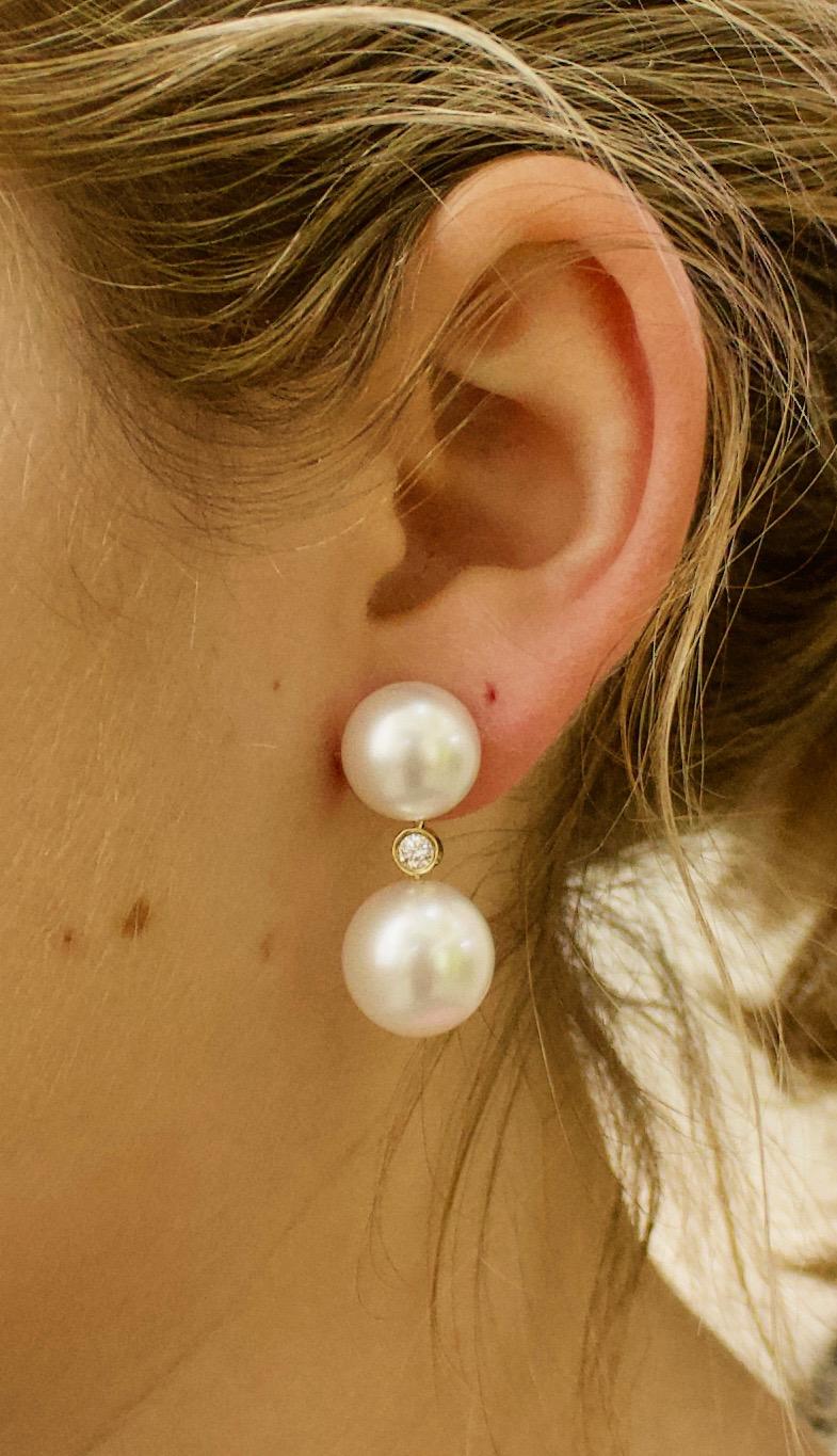 Dangling Double South Sea Pearl and Diamond Earrings 12.3mm and 13.5mm
Four South Sea Pearls 
Two Round Brilliant Cut Diamonds Weighing .25 Carats Approximately 
